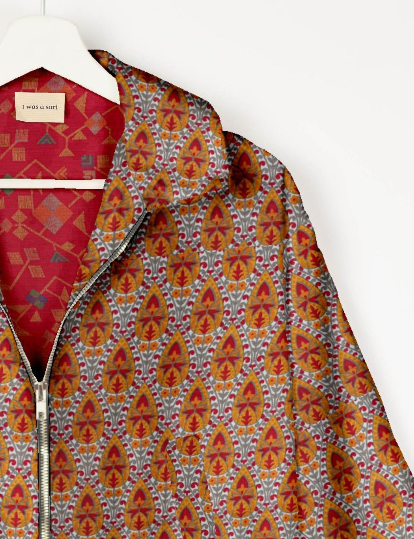 Upcycled Bomber Jacket made from recycled sari materials, featuring a cute cropped shape, elasticated hem and cuffs, and contrast sari print lining. Sustainable apparel promoting eco-friendly fashion and ethical clothing.