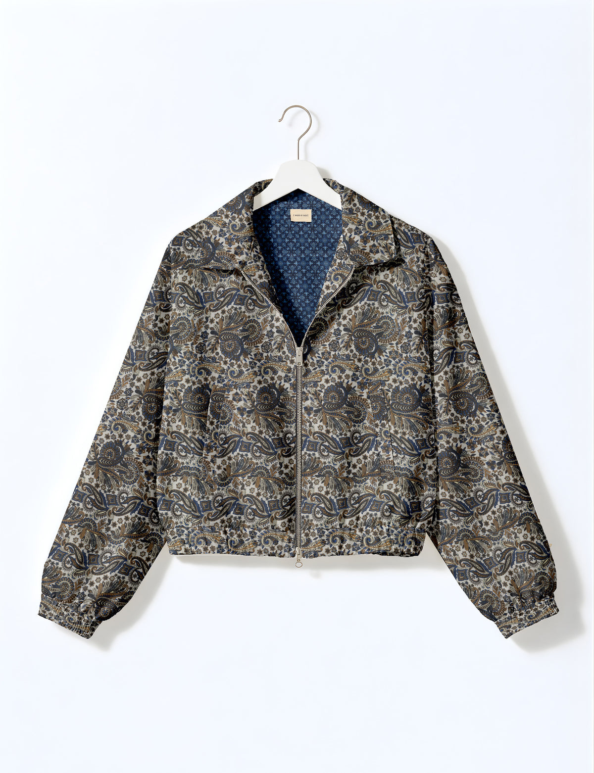 Brown floral bomber jacket with front zipper, elastic cuffs and hem, hanging on white hanger, red floral inner lining visible