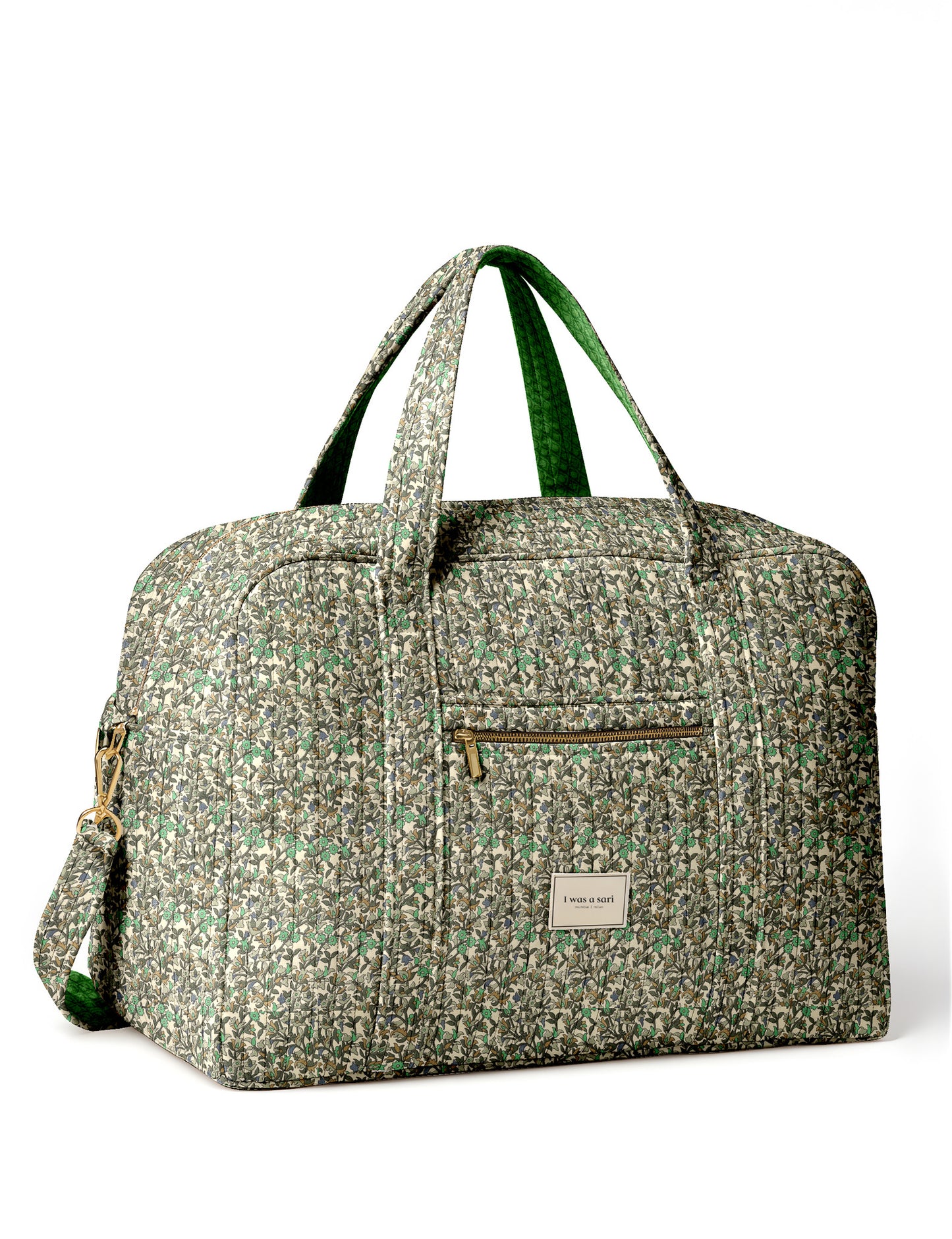 Brown quilted duffle bag with paisley pattern, front zip pocket, dual handles, and label reading "I was a sari"