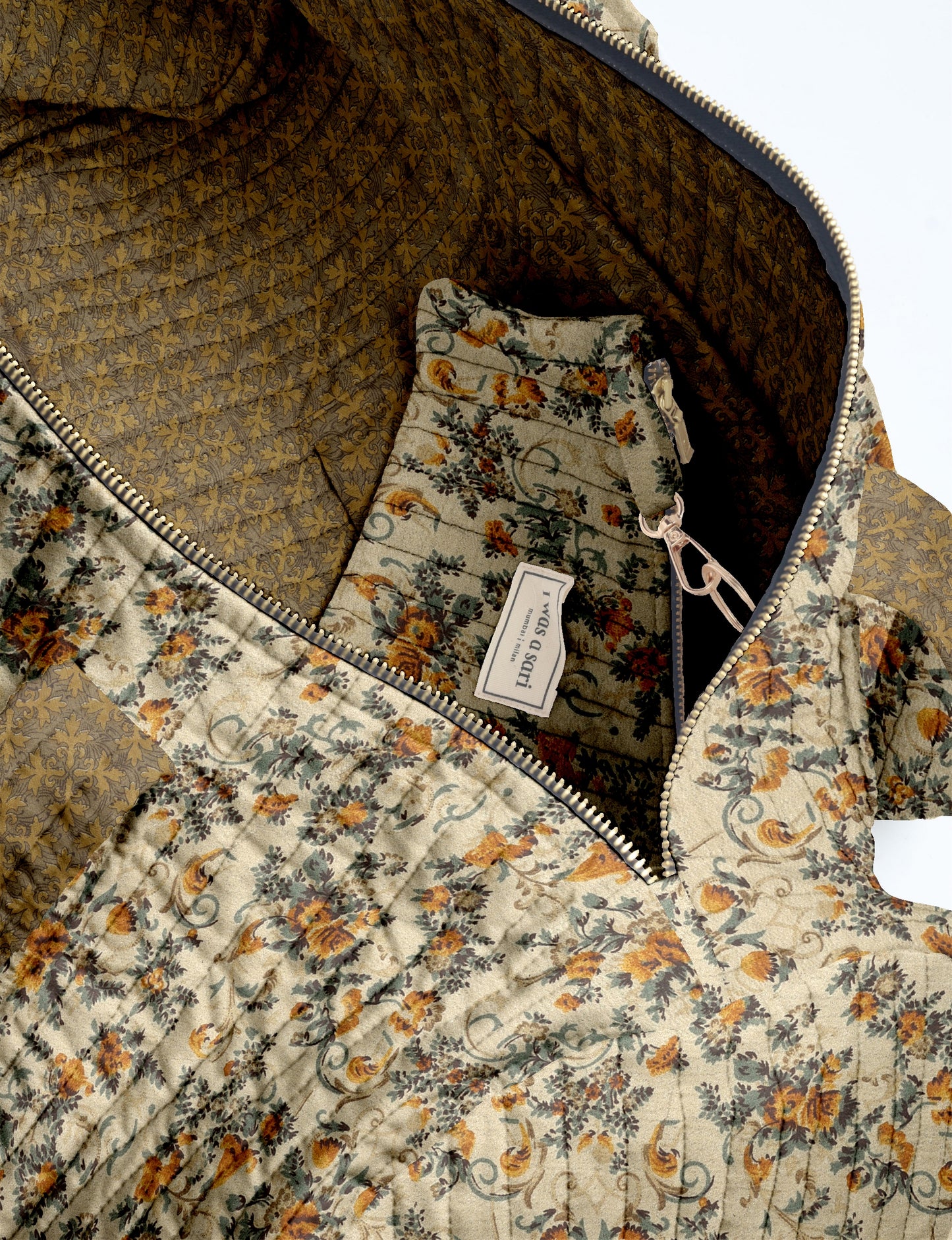 Woman wearing light blue jeans and white sneakers holding a beige quilted bowling bag with micro floral design and front