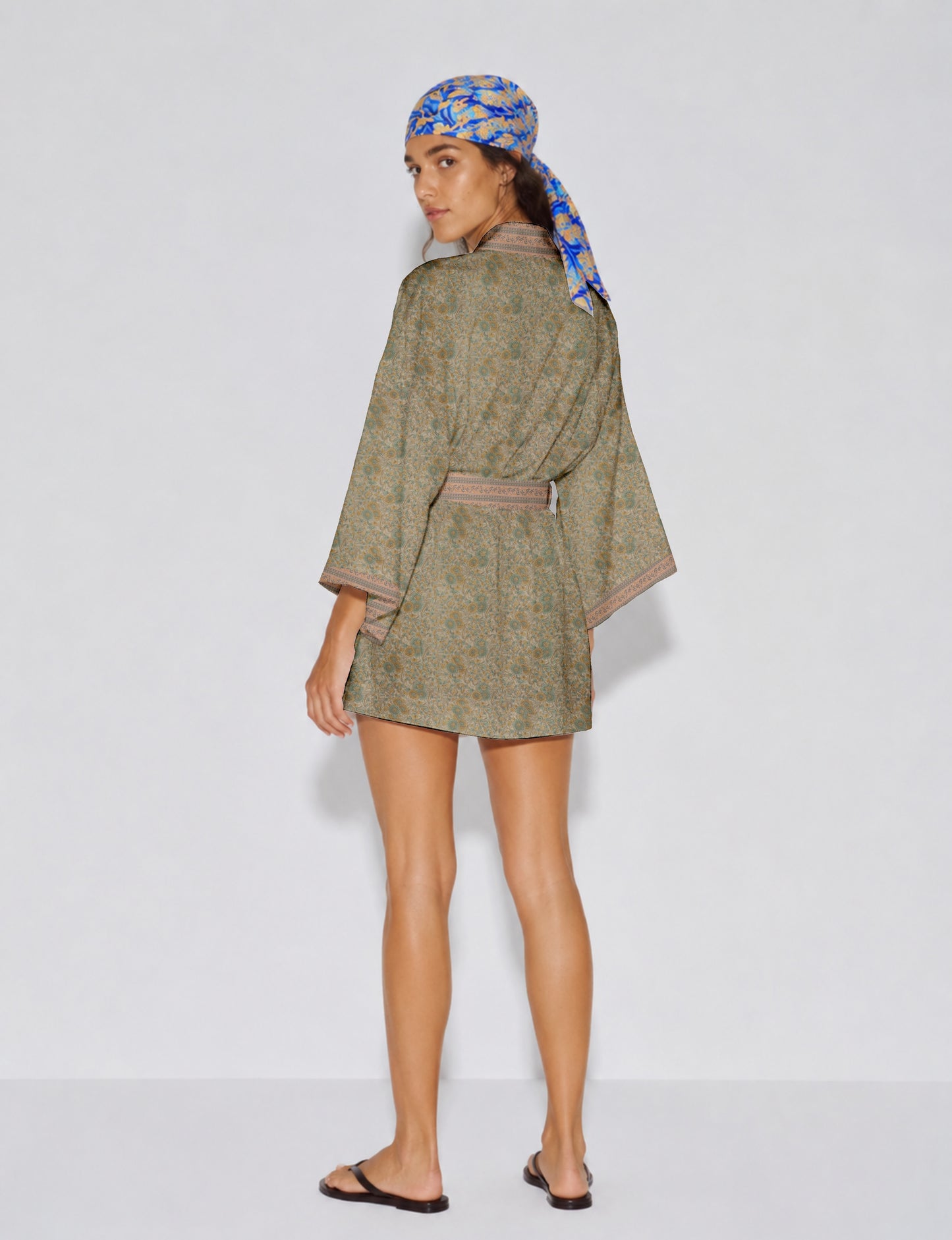 Short kimono robe with wrap front, V-neckline, wide sleeves, waist tie, and concealed skort detail.