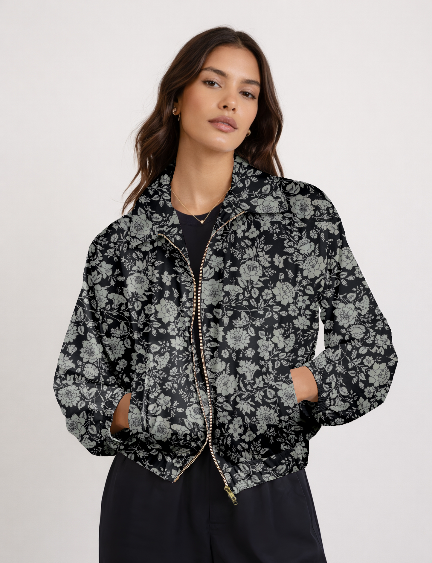 Women's cropped bomber jacket with twin metallic front zippers, welt pockets, elasticated hem and cuffs, and contrast sari print lining.