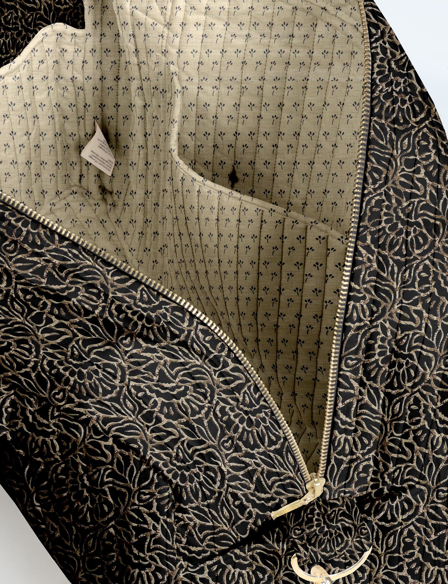 Brown quilted duffle bag with paisley pattern, front zip pocket, dual handles, and label reading "I was a sari"