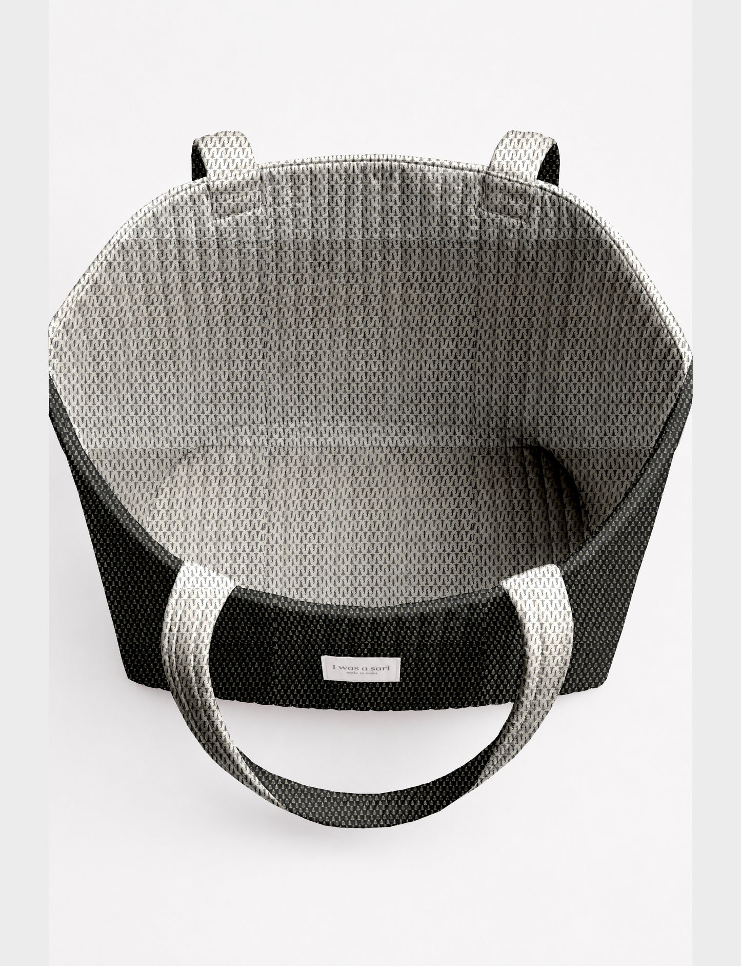 Large quilted beach bag with spacious rectangular design, reinforced shoulder straps, and open-top construction for everyday use and travel.
