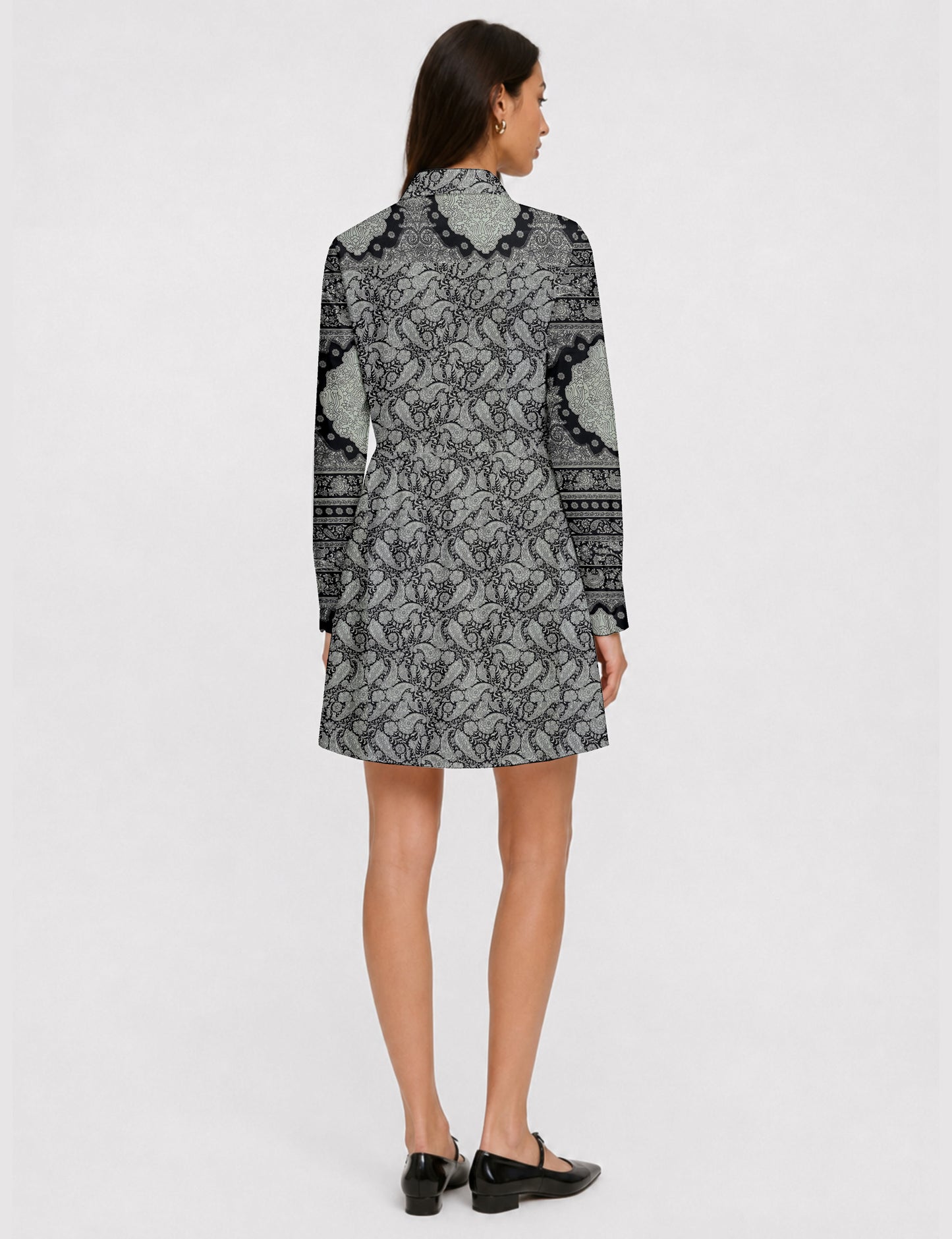 Short shirt dress with a relaxed A-line silhouette, point collar, partial button placket, gathered waist, side pockets, and full-length cuffed sleeves.
