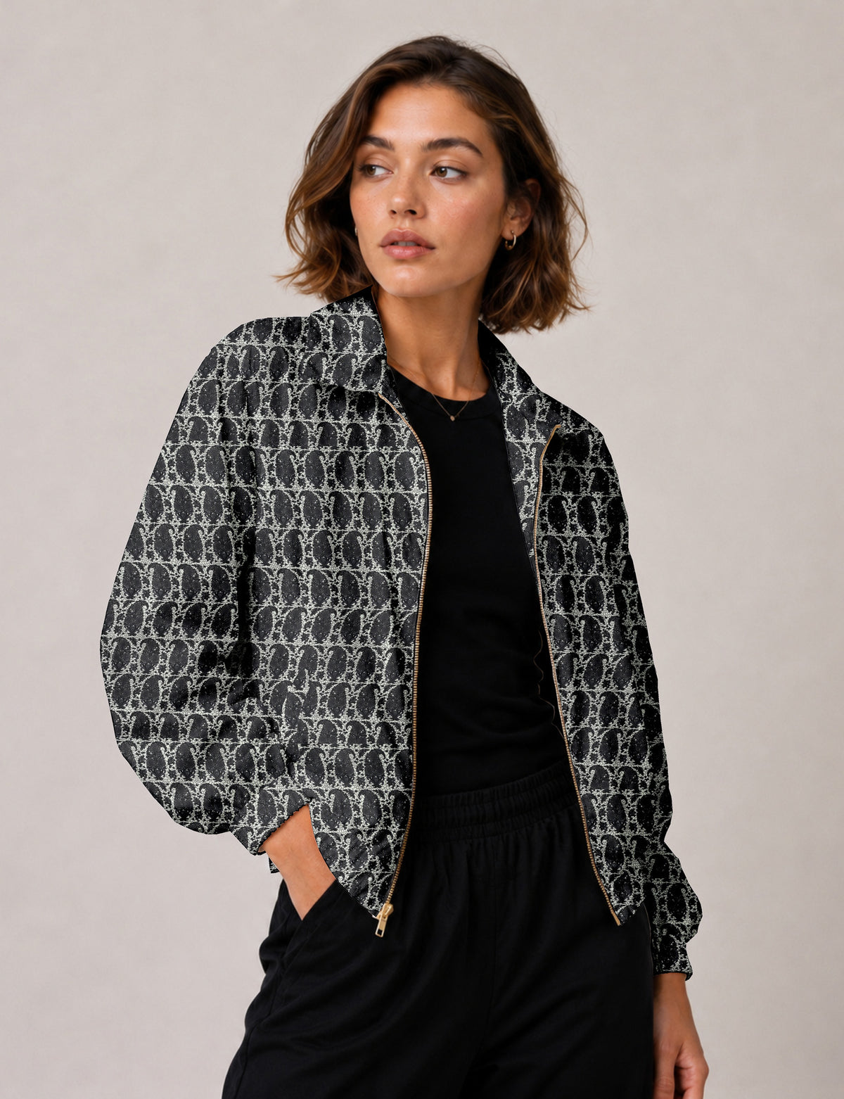 Brown floral bomber jacket with front zipper, elastic cuffs and hem, hanging on white hanger, red floral inner lining visible