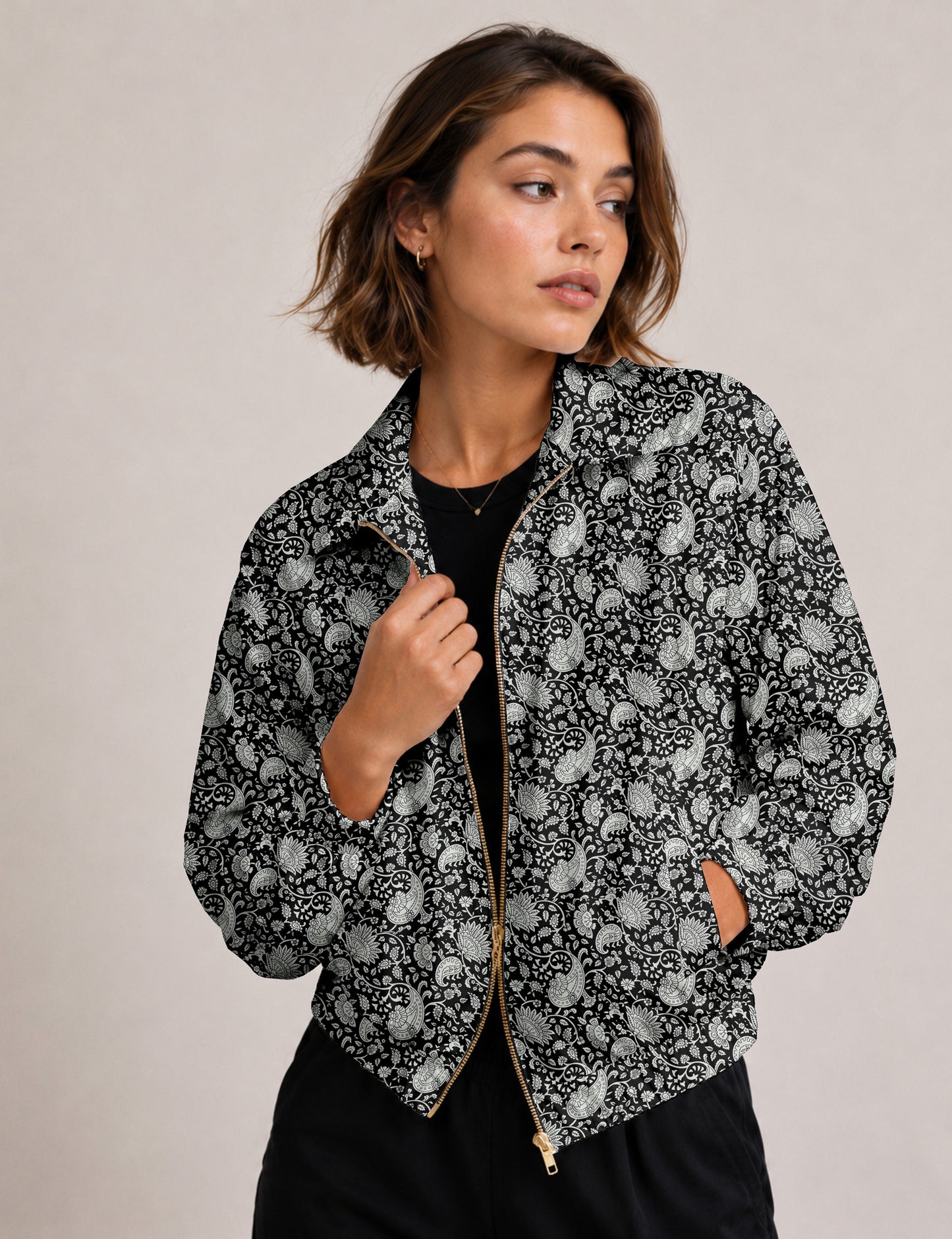 Woman wearing a yellow floral bomber jacket with front zipper, elastic cuffs, and side pockets, shown from front view