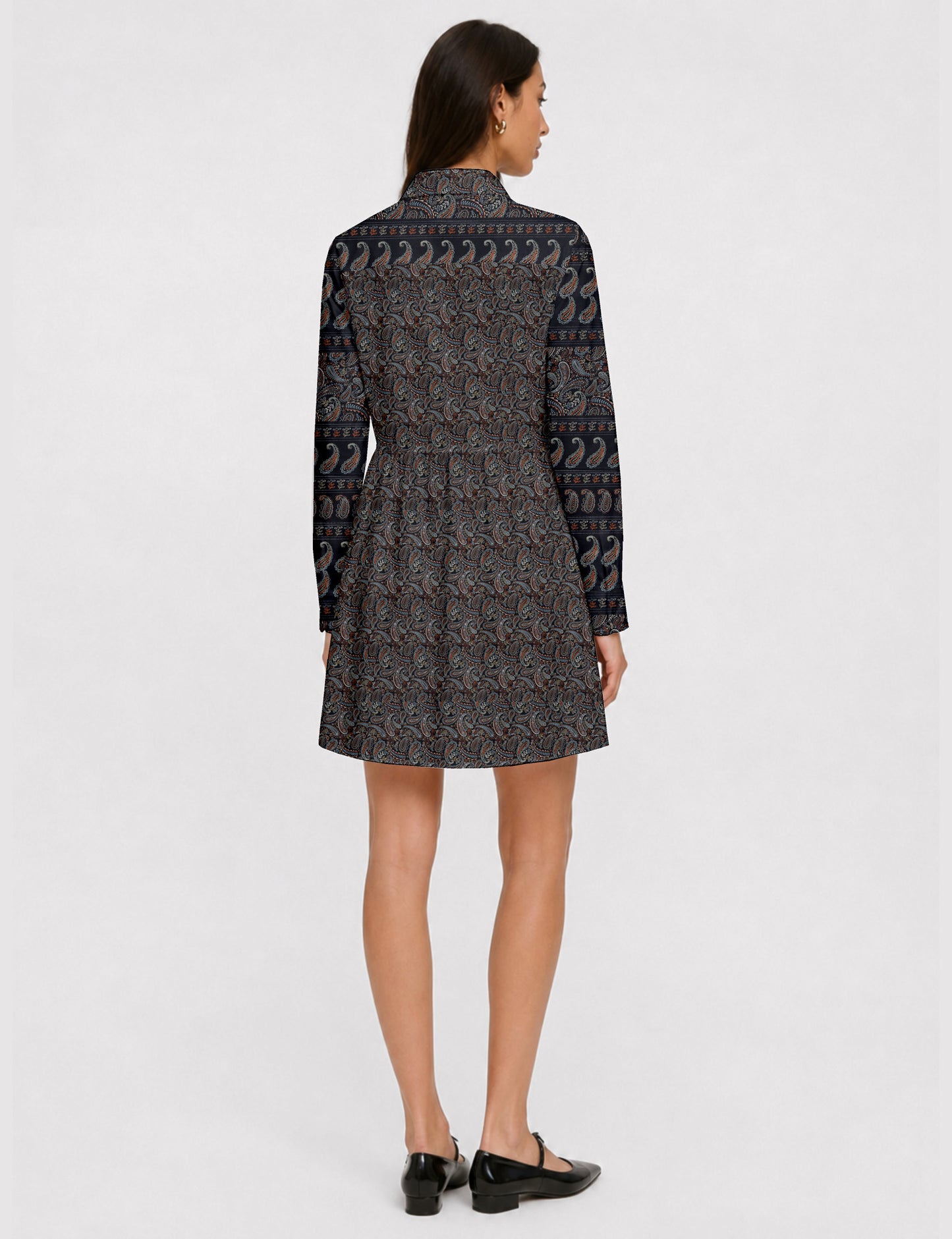 Short shirt dress with a relaxed A-line silhouette, point collar, partial button placket, gathered waist, side pockets, and full-length cuffed sleeves.