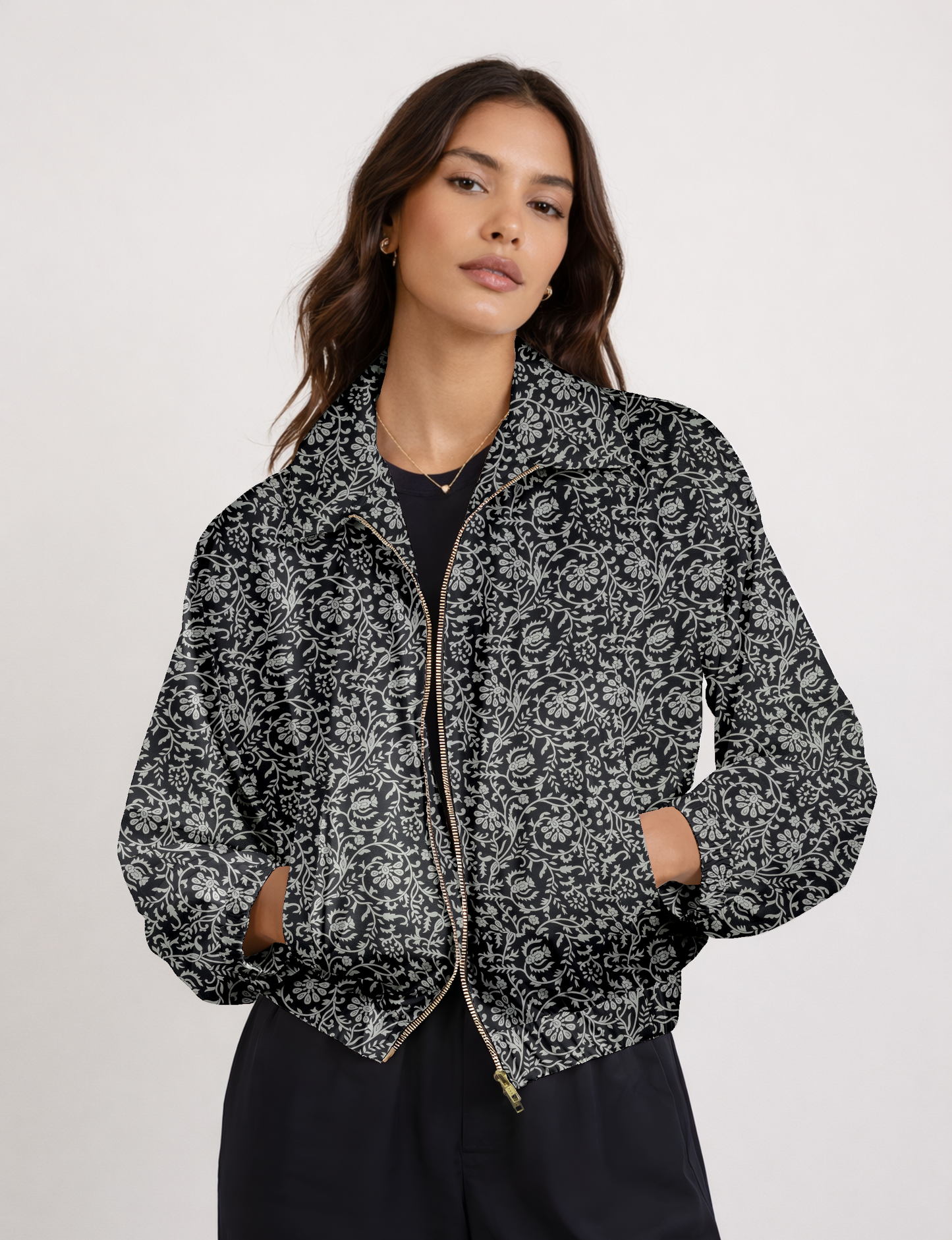 Women's cropped bomber jacket with twin metallic front zippers, welt pockets, elasticated hem and cuffs, and contrast sari print lining.