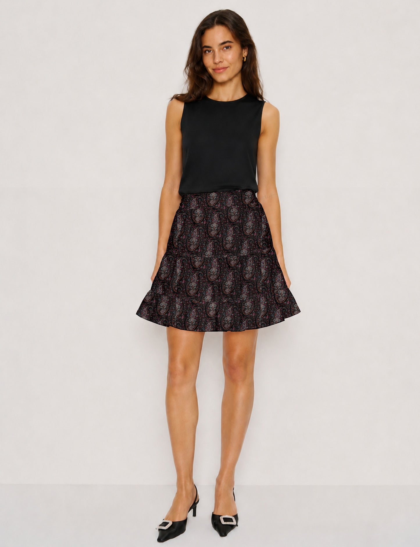 Short tiered skirt with a fitted waistband, knife pleats, softly flared silhouette, side seam pockets, and above-the-knee length.