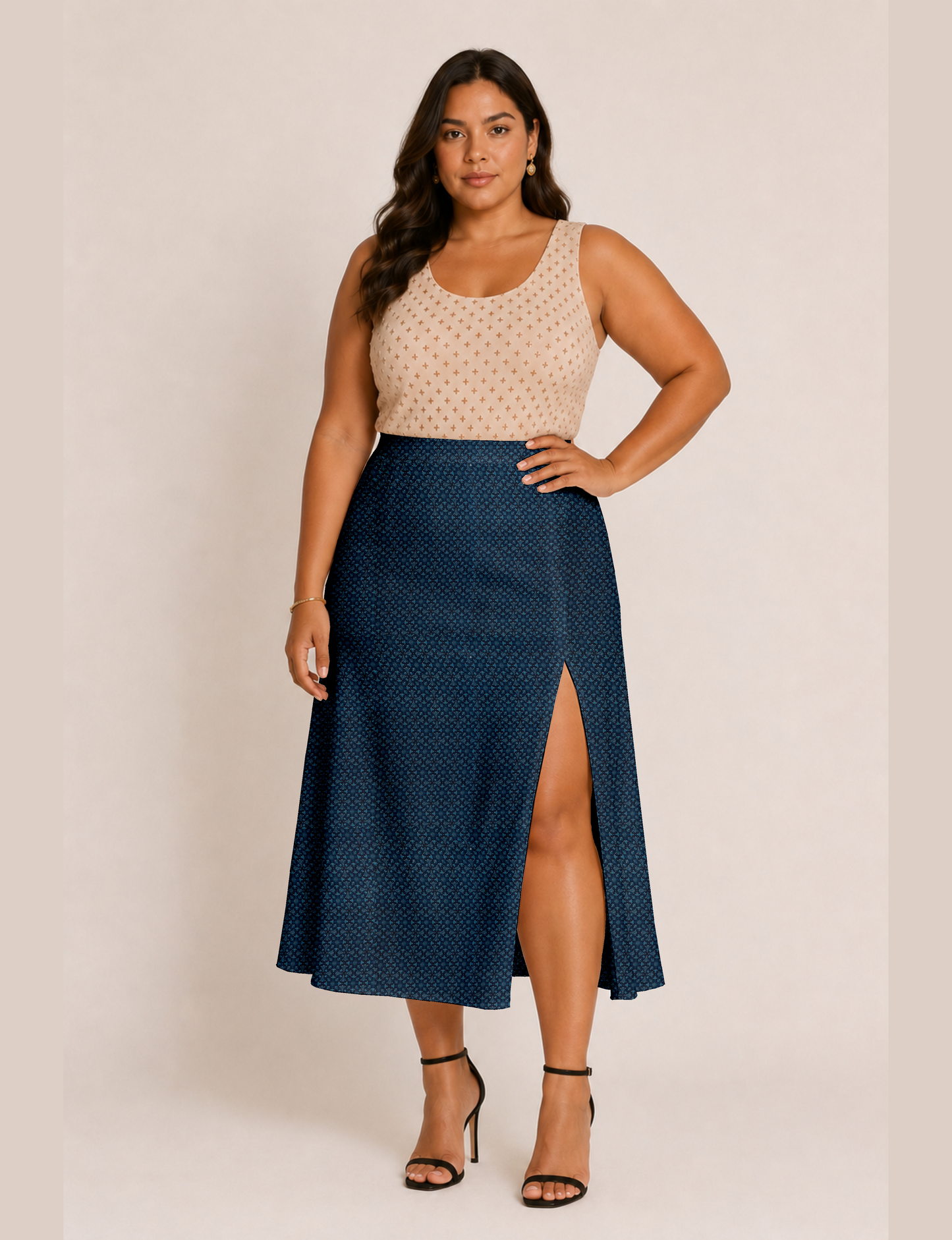 Woman wearing a yellow and black micro patterned A-line skirt with front slit, paired with beige sleeveless top and black