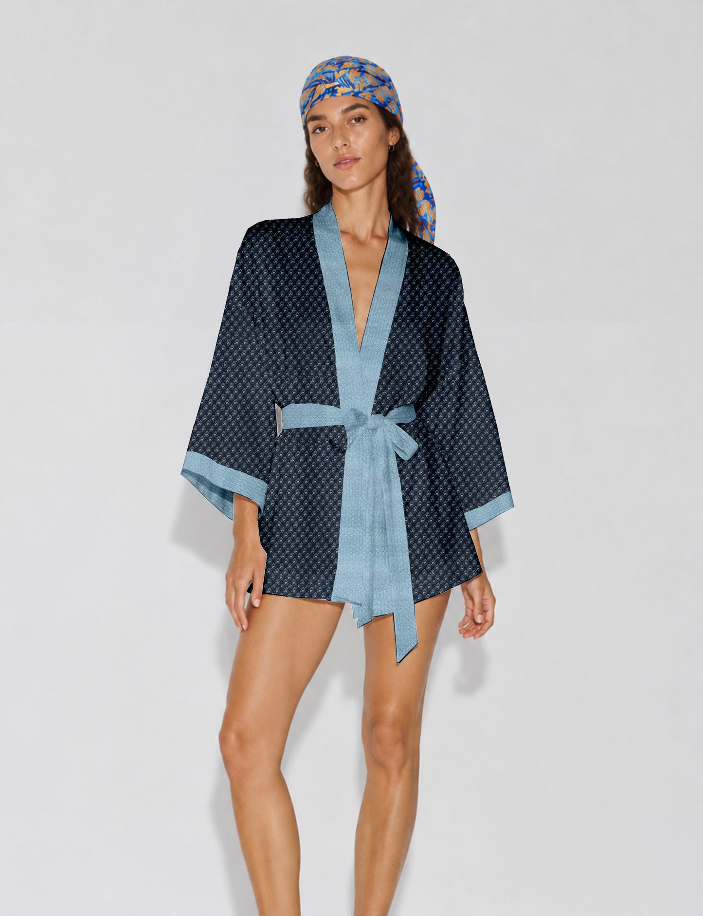 Short kimono robe with wrap front, V-neckline, wide sleeves, waist tie, and concealed skort detail.