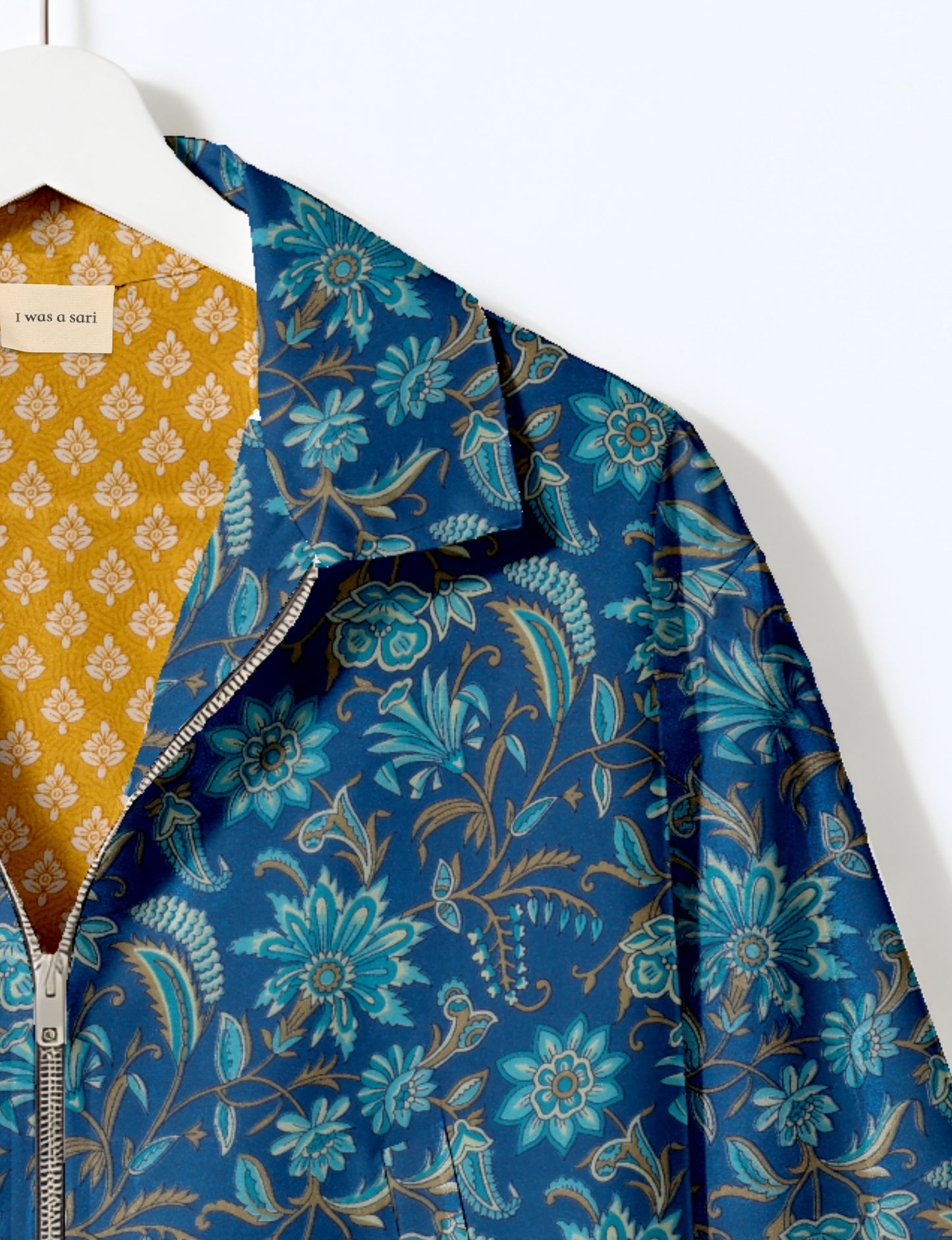 Upcycled Bomber Jacket made from recycled sari materials, featuring a cute cropped shape, elasticated hem and cuffs, and contrast sari print lining. Sustainable apparel promoting eco-friendly fashion and ethical clothing.