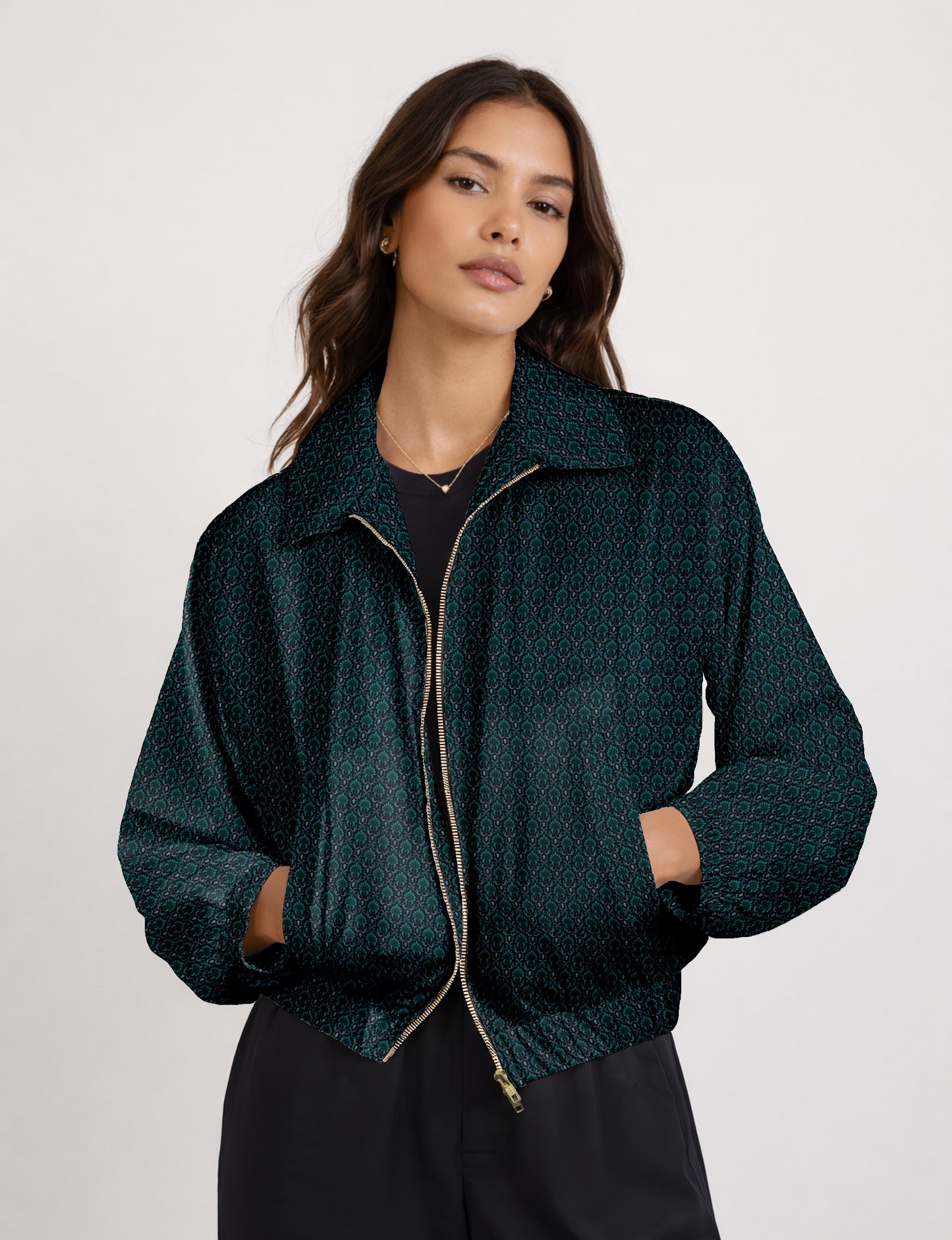 Women's cropped bomber jacket with twin metallic front zippers, welt pockets, elasticated hem and cuffs, and contrast sari print lining.