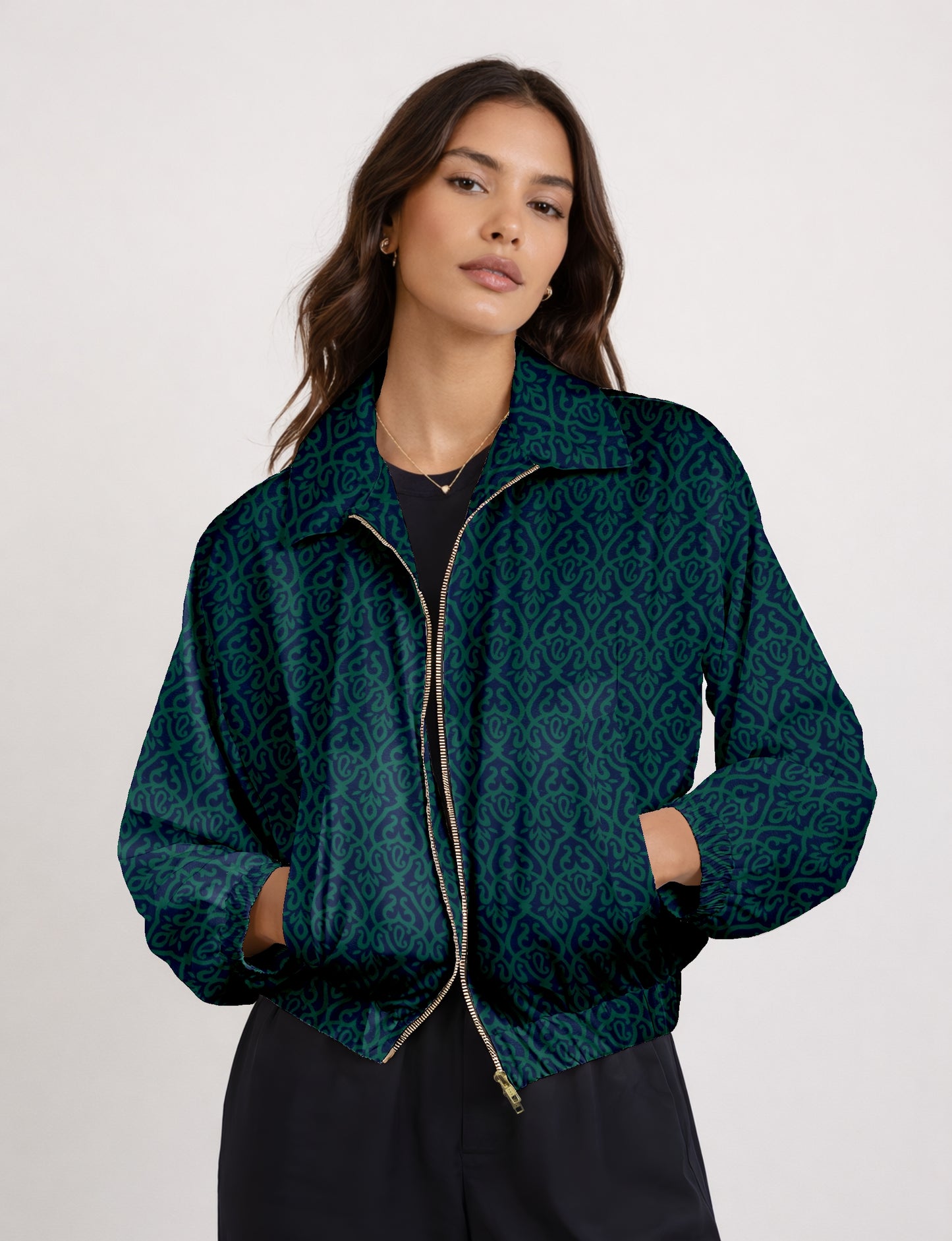 Women's cropped bomber jacket with twin metallic front zippers, welt pockets, elasticated hem and cuffs, and contrast sari print lining.