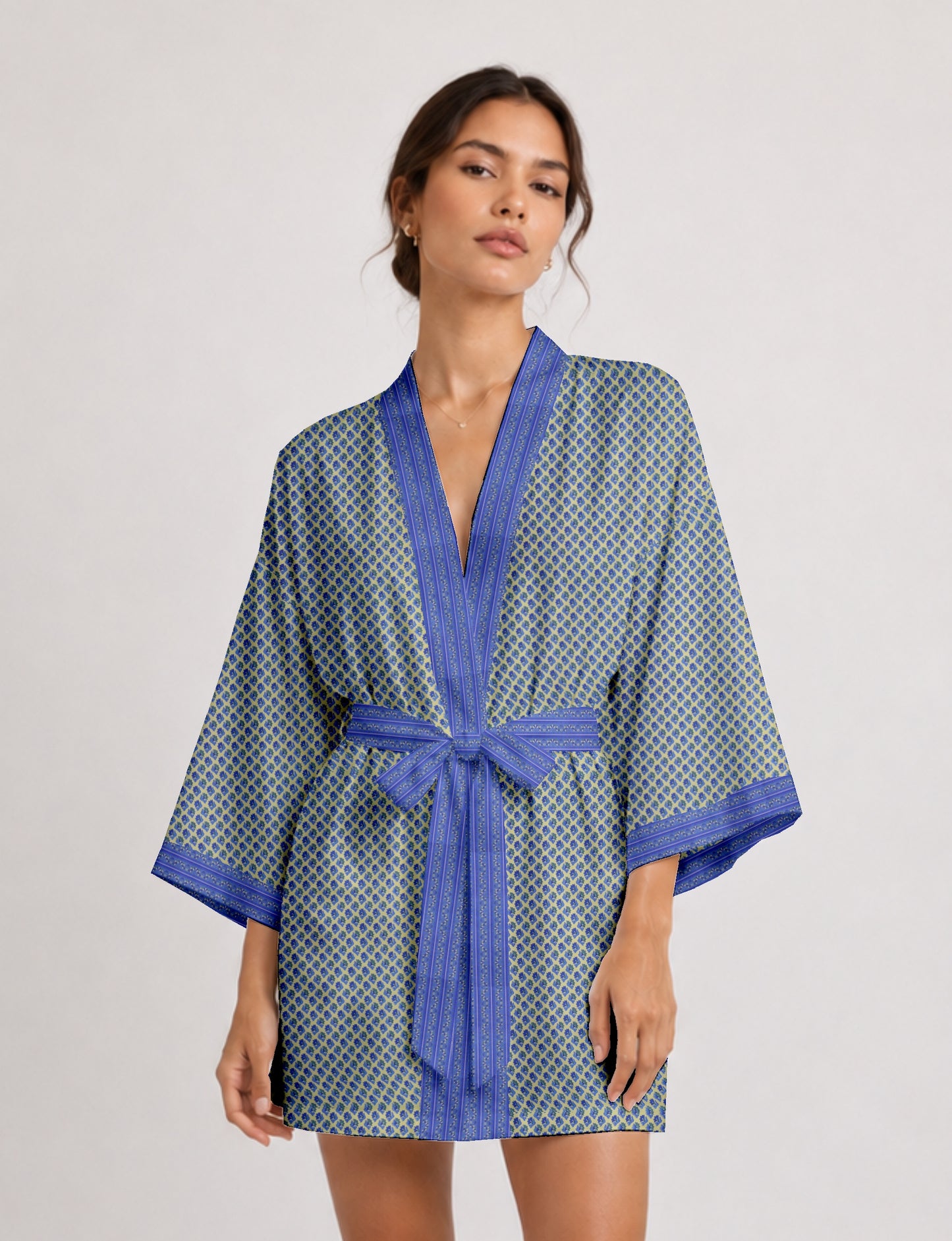 Short kimono robe with wrap front, V-neckline, wide sleeves, waist tie, and concealed skort detail.