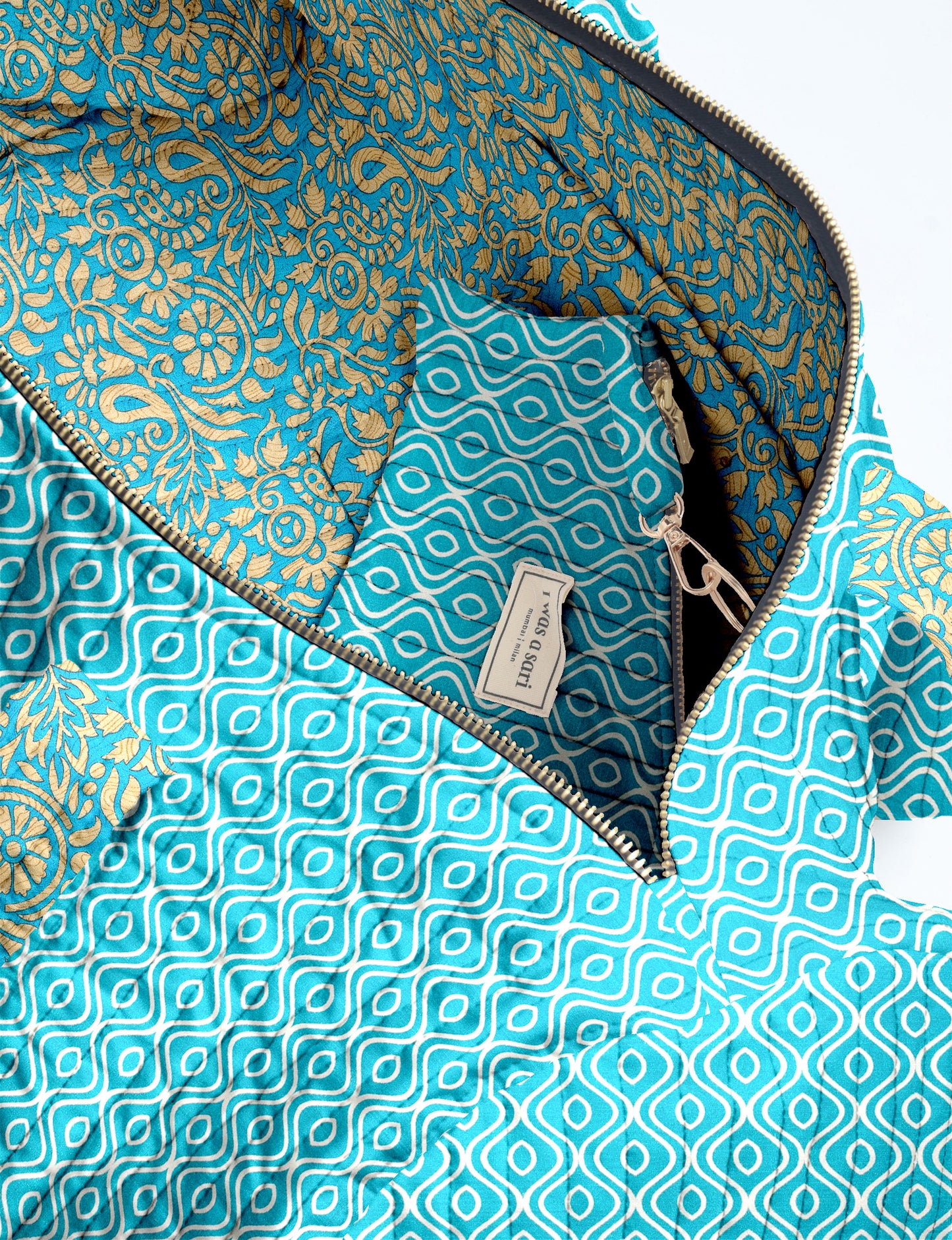 Quilted brown paisley bowling bag with gold zipper, floral interior lining, and interior key clip with label inside pocket