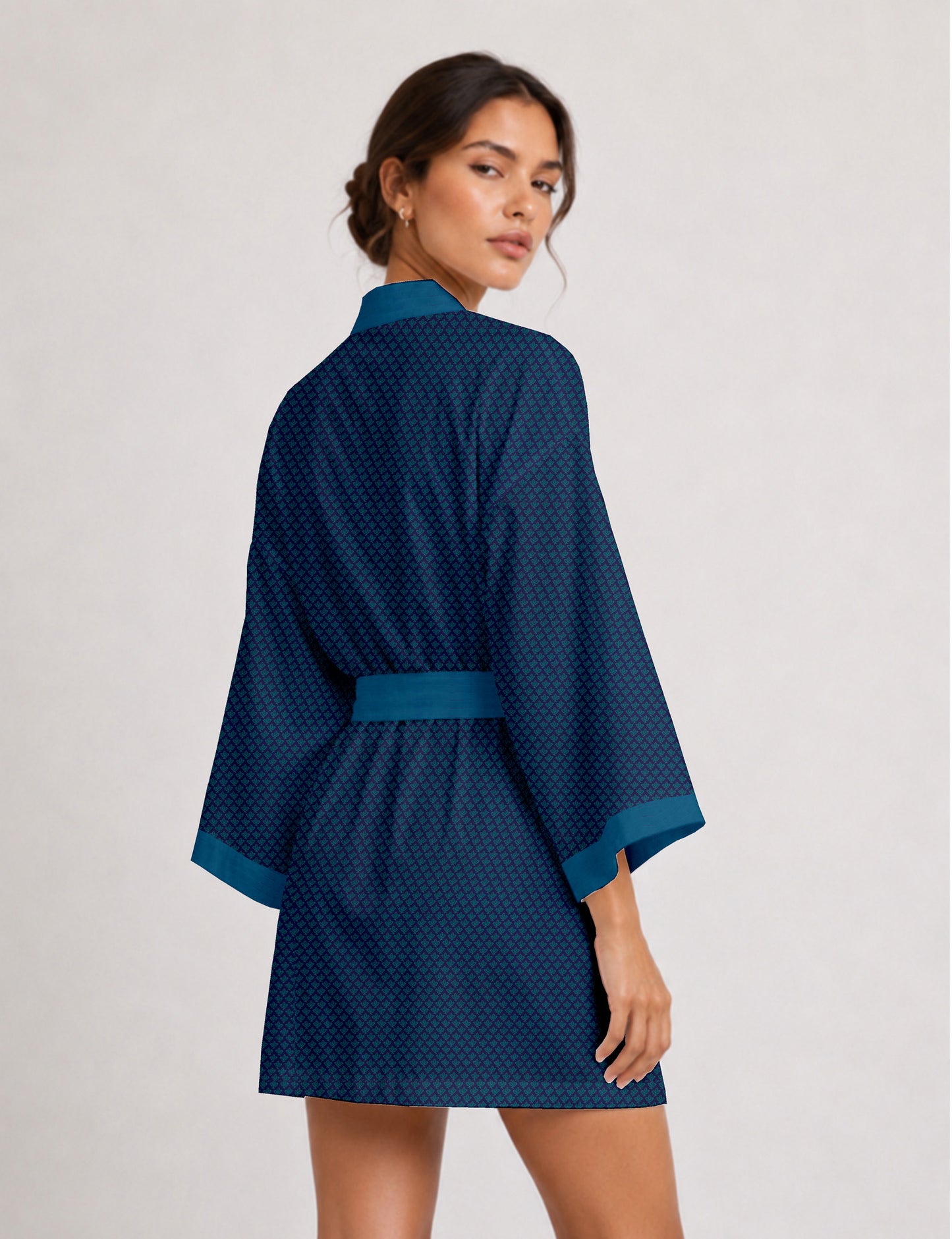 Short kimono robe with wrap front, V-neckline, wide sleeves, waist tie, and concealed skort detail.