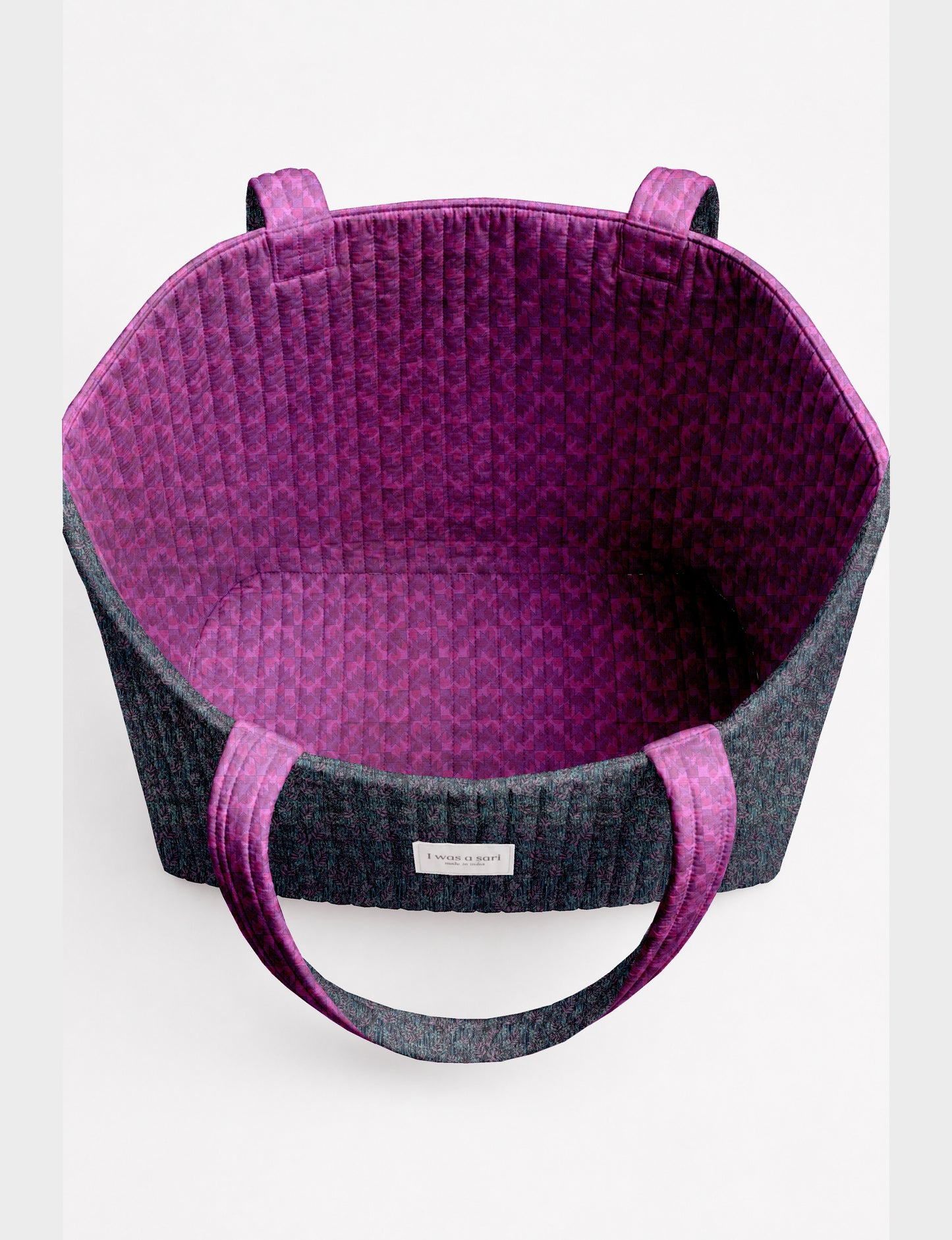 Large quilted beach bag with spacious rectangular design, reinforced shoulder straps, and open-top construction for everyday use and travel.