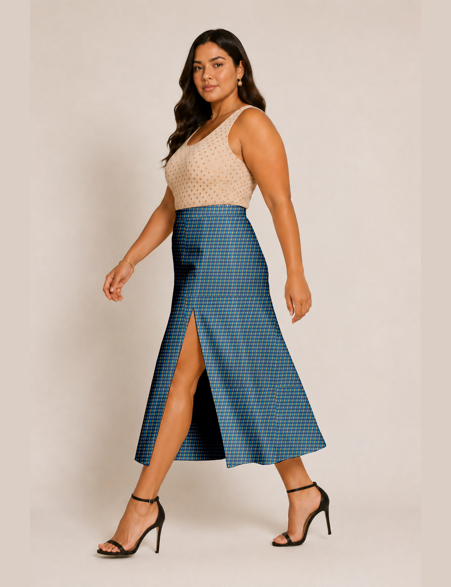 Woman wearing a yellow and black micro patterned A-line skirt with front slit, paired with beige sleeveless top and black