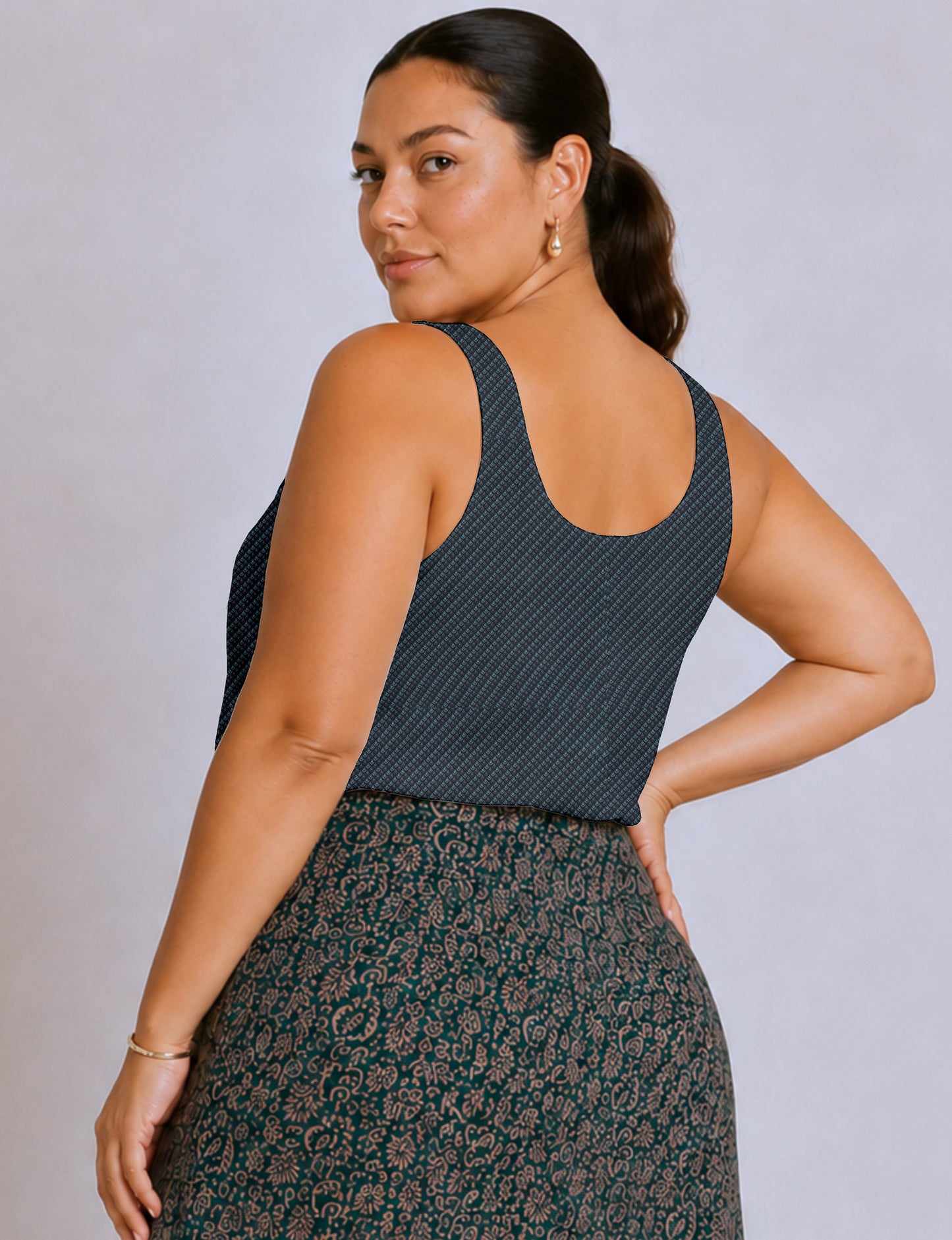 Women's sleeveless blouse with a relaxed straight fit, wide scoop neckline, deep scoop back, and hip-length silhouette.