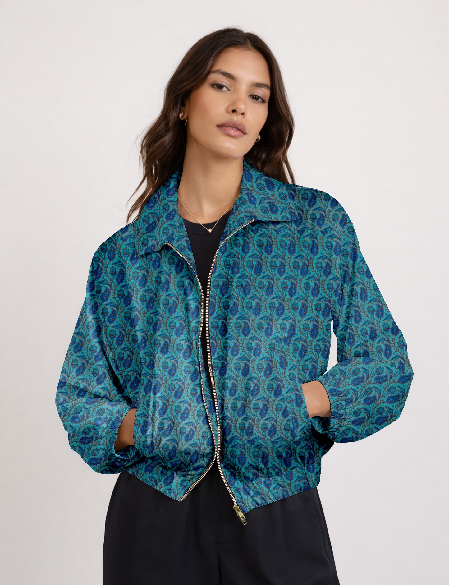 Women's cropped bomber jacket with twin metallic front zippers, welt pockets, elasticated hem and cuffs, and contrast sari print lining.