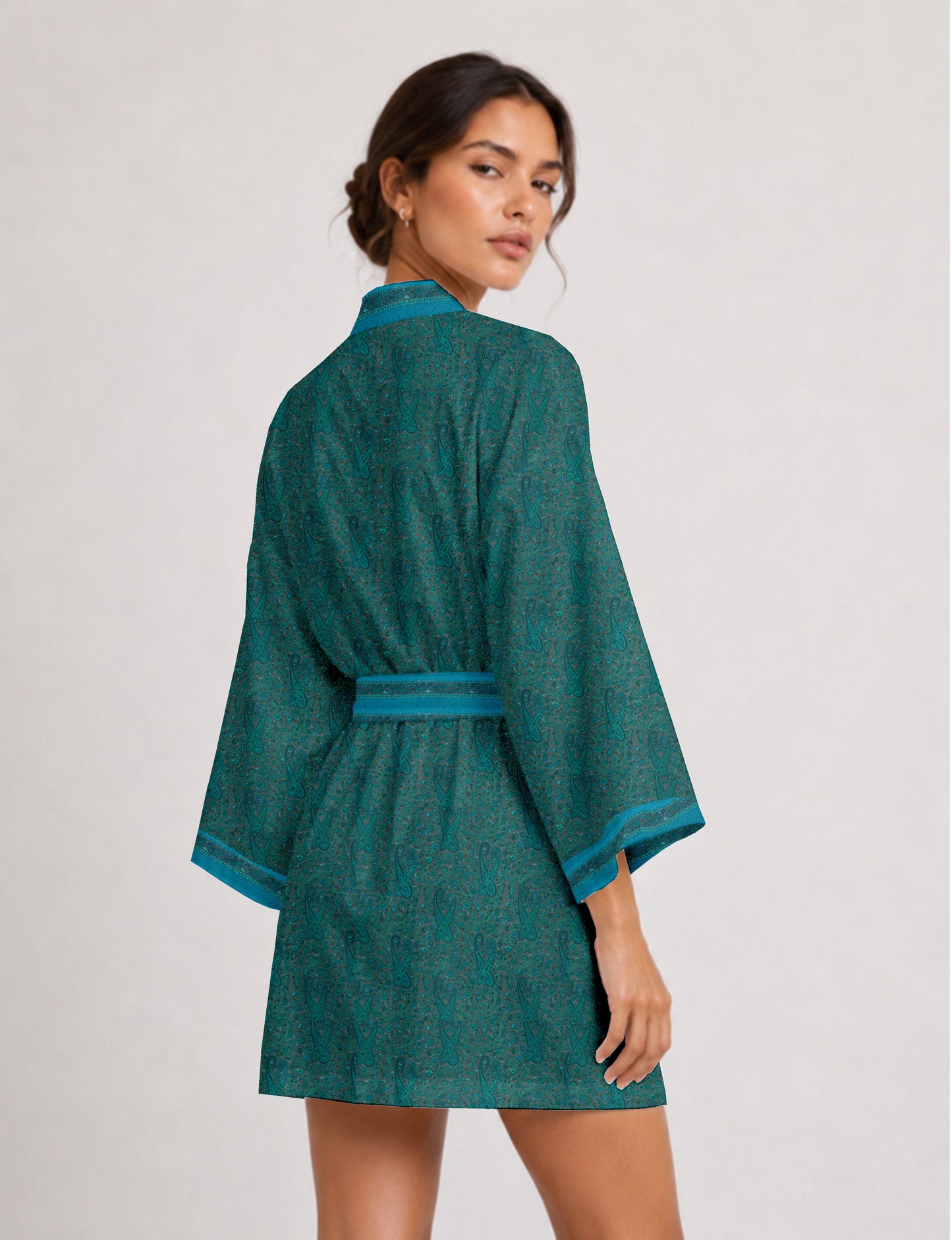 Short kimono robe with wrap front, V-neckline, wide sleeves, waist tie, and concealed skort detail.
