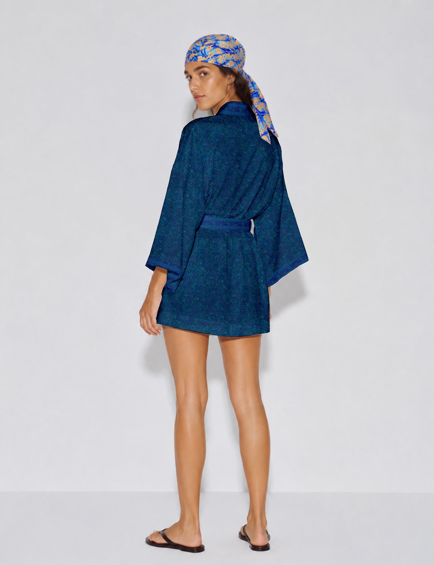 Short kimono robe with wrap front, V-neckline, wide sleeves, waist tie, and concealed skort detail.