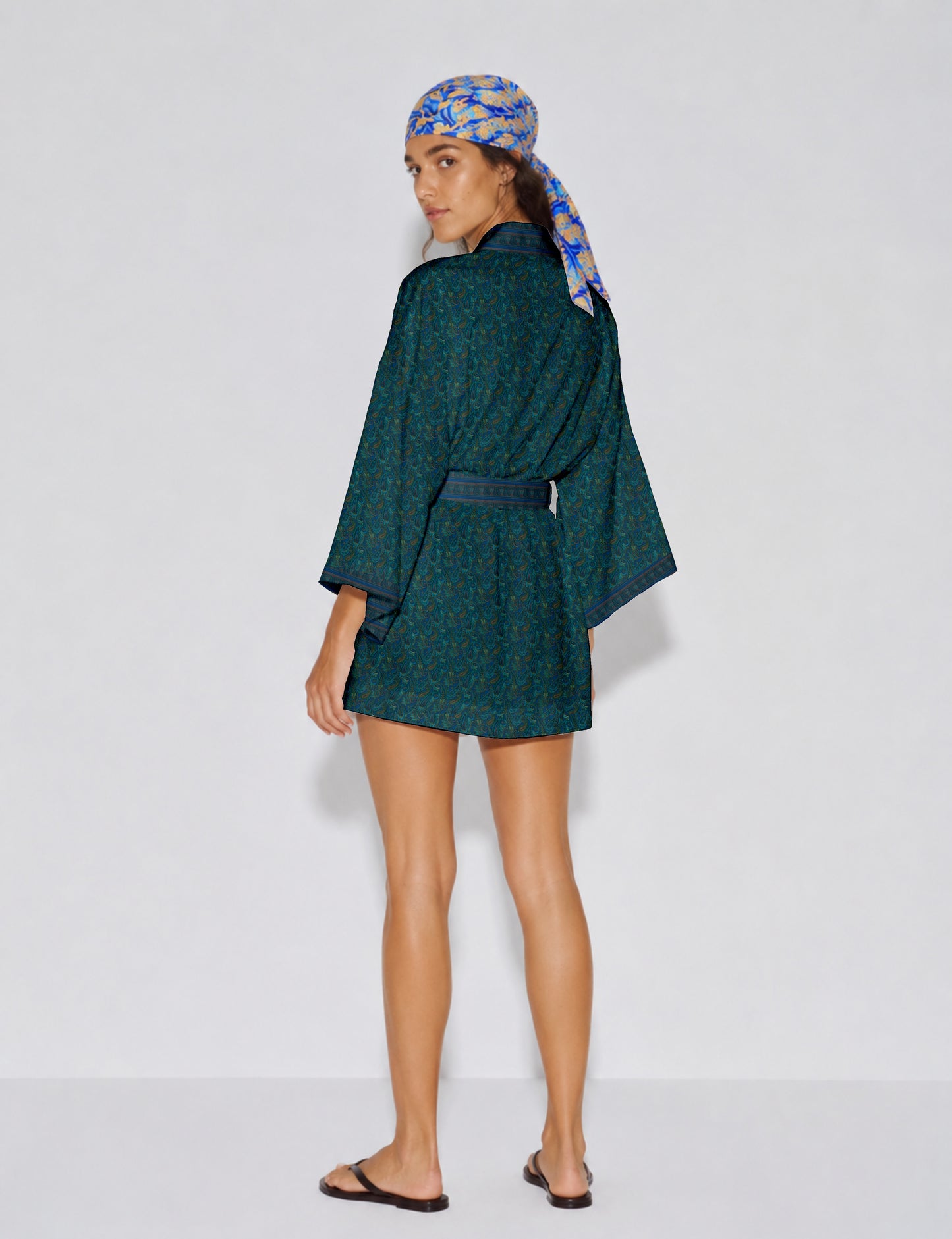 Short kimono robe with wrap front, V-neckline, wide sleeves, waist tie, and concealed skort detail.