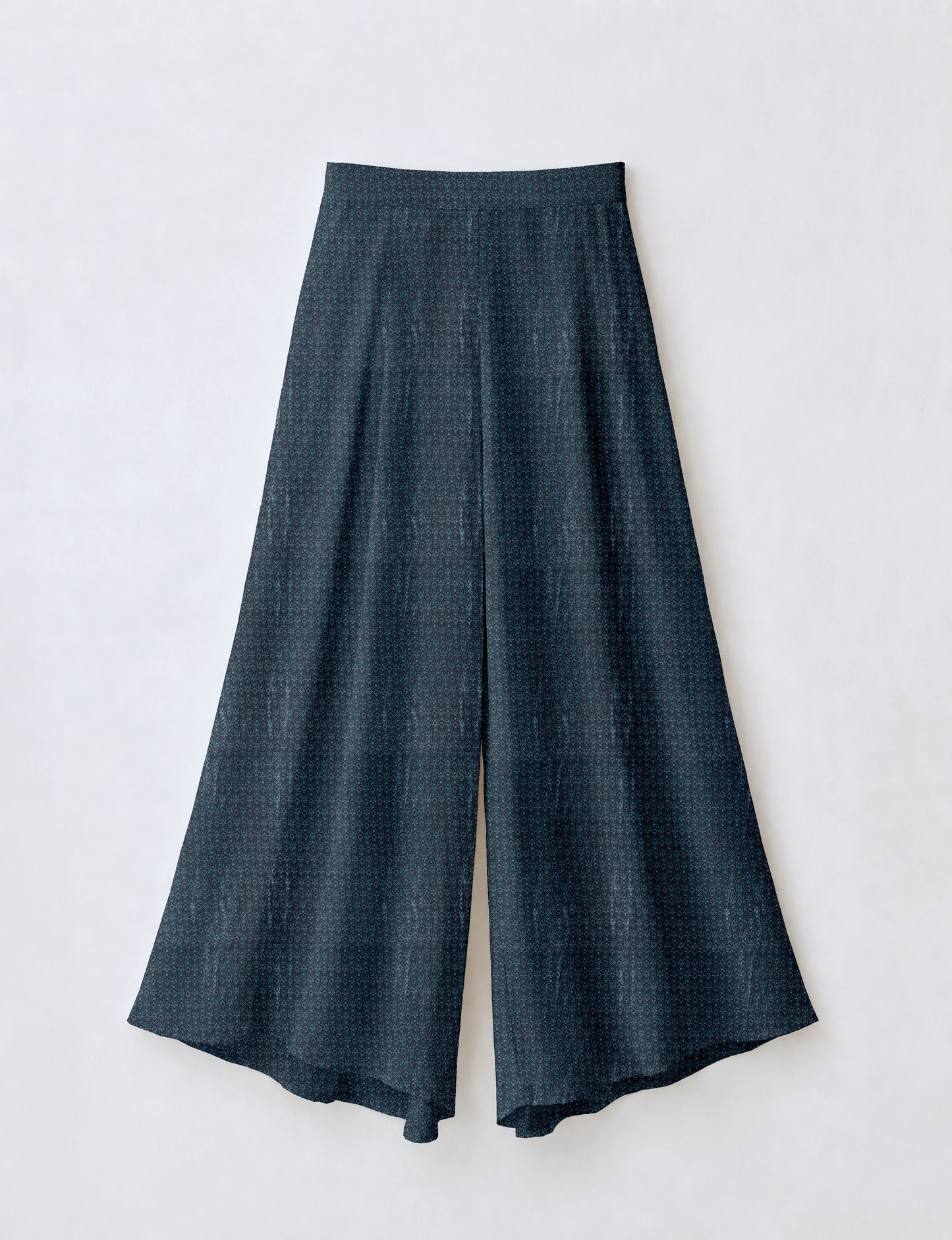 Blue wide leg palazzo trousers with a small tropical floral pattern, flat lay front view