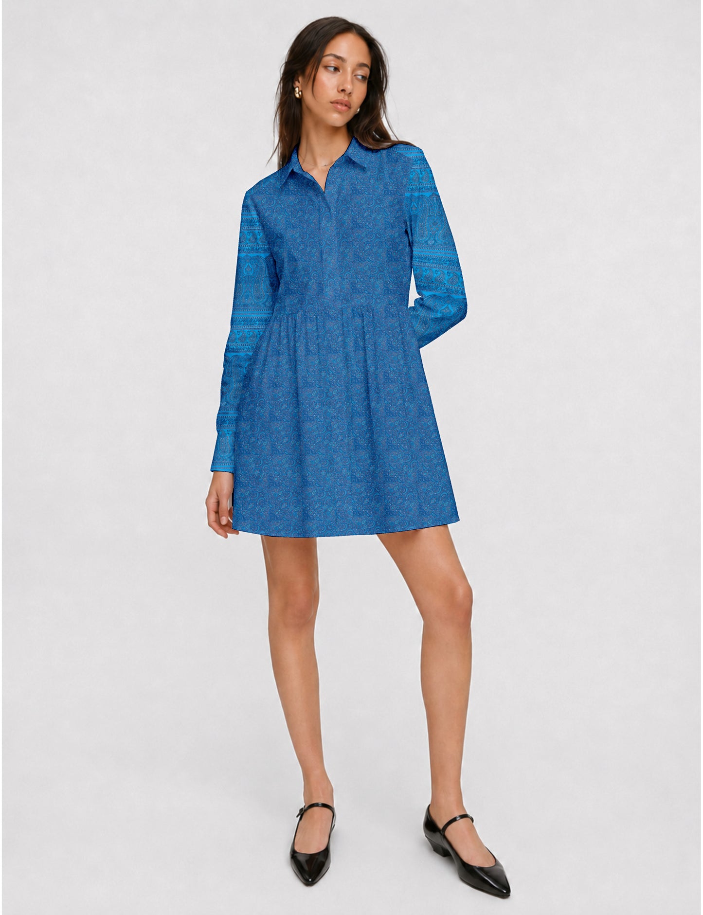 Short shirt dress with a relaxed A-line silhouette, point collar, partial button placket, gathered waist, side pockets, and full-length cuffed sleeves.