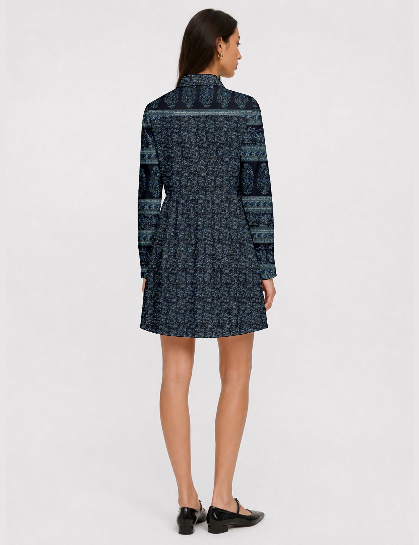 Short shirt dress with a relaxed A-line silhouette, point collar, partial button placket, gathered waist, side pockets, and full-length cuffed sleeves.