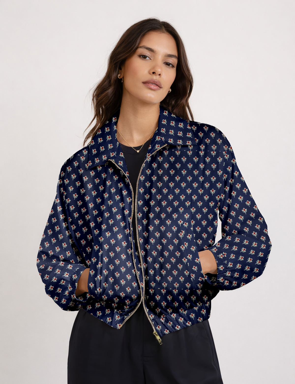 Brown floral bomber jacket with front zipper, elastic cuffs and hem, hanging on white hanger, red floral inner lining visible