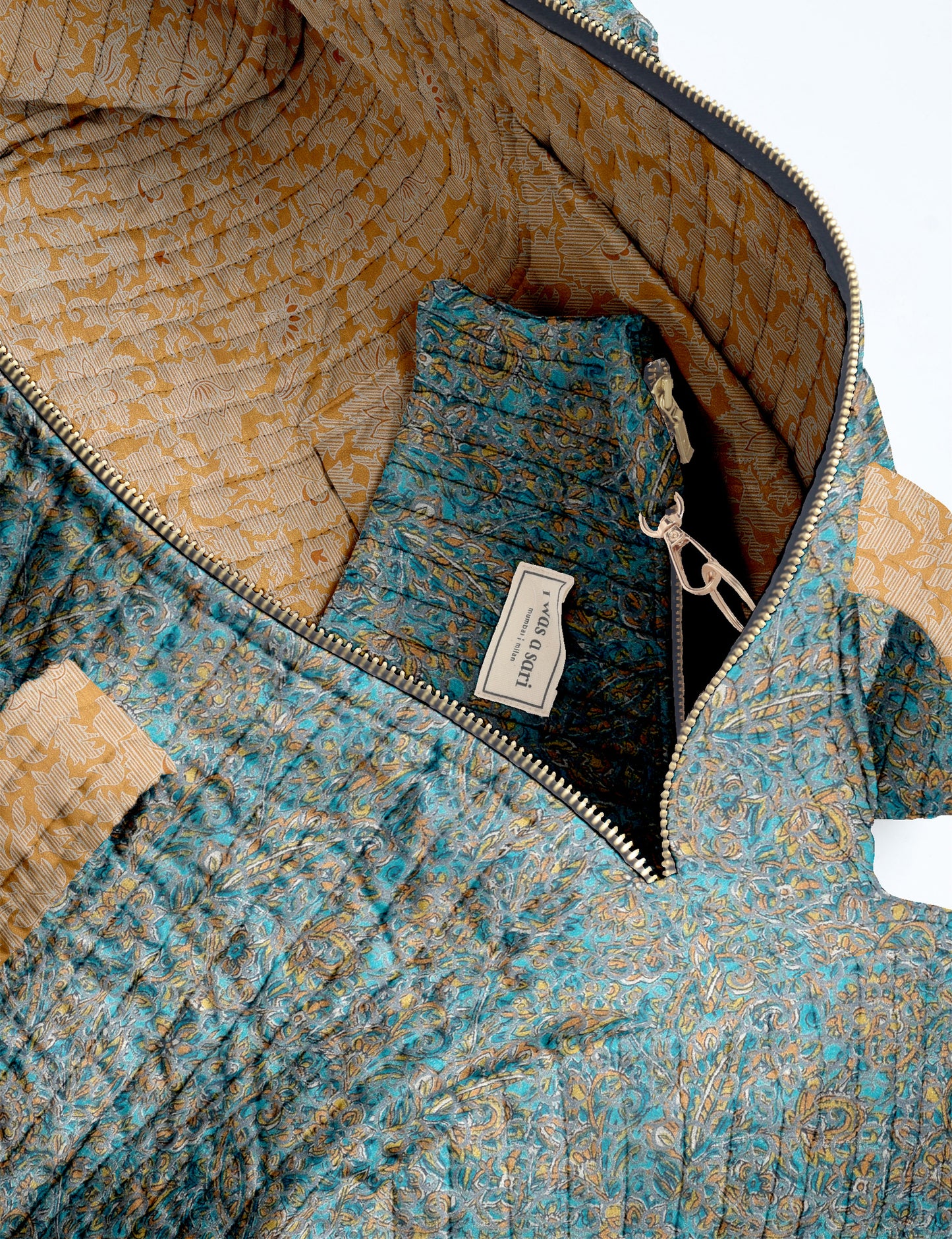 Brown paisley quilted bowling bag with dual handles, front zipper pocket, and "I was a sari" label on front side