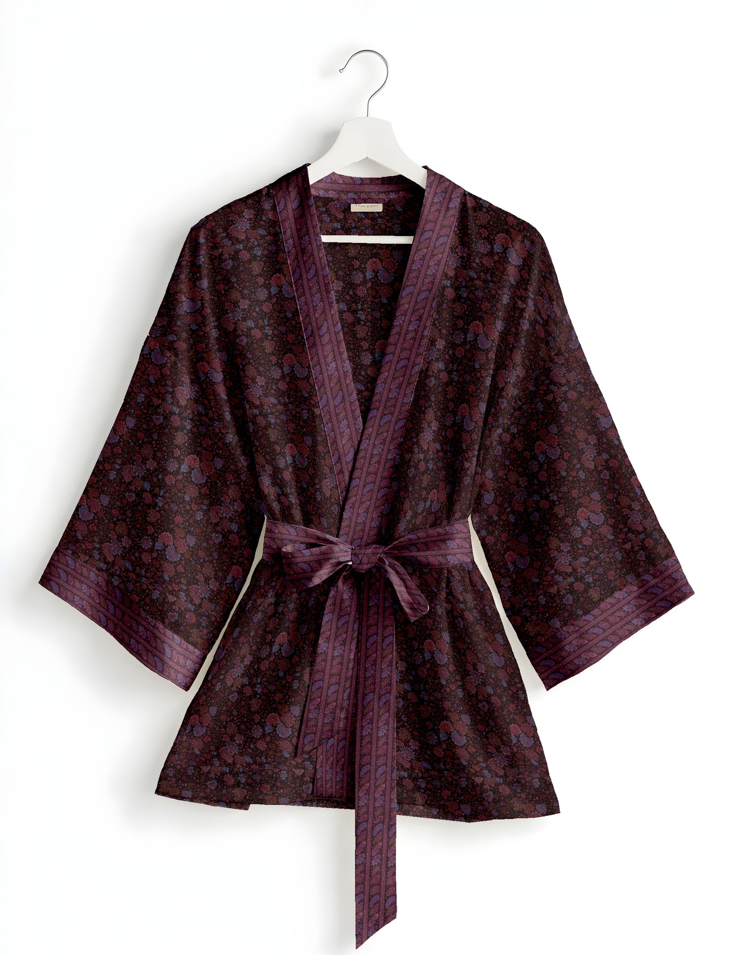 Short kimono robe with wrap front, V-neckline, wide sleeves, waist tie, and concealed skort detail.