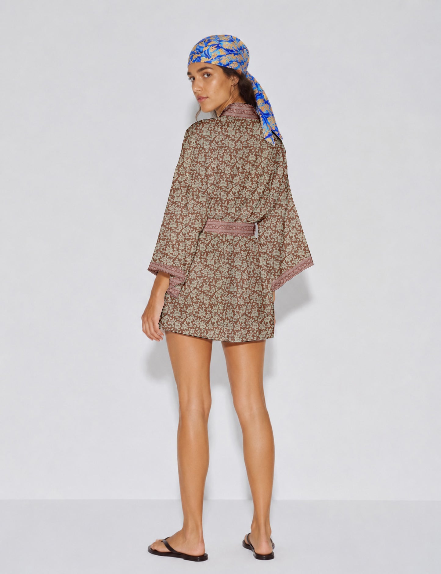 Short kimono robe with wrap front, V-neckline, wide sleeves, waist tie, and concealed skort detail.