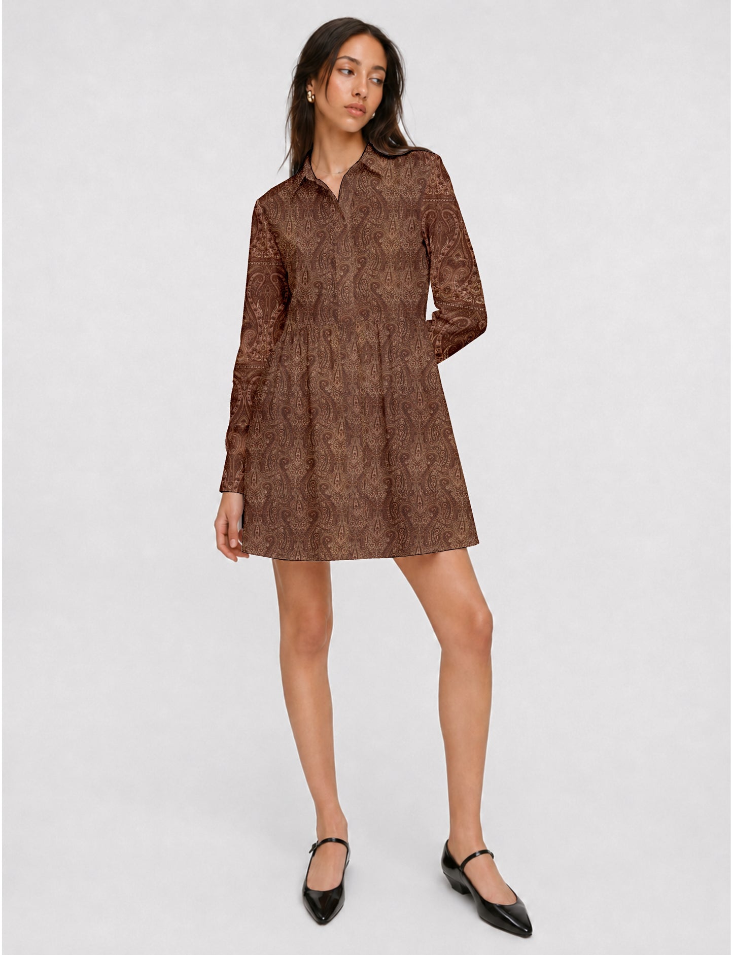 Short shirt dress with a relaxed A-line silhouette, point collar, partial button placket, gathered waist, side pockets, and full-length cuffed sleeves.