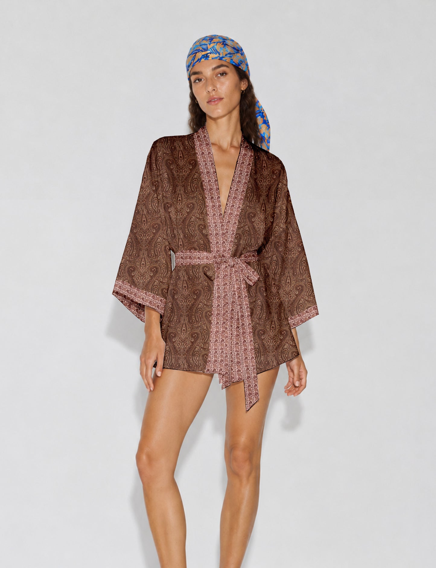 Short kimono robe with wrap front, V-neckline, wide sleeves, waist tie, and concealed skort detail.