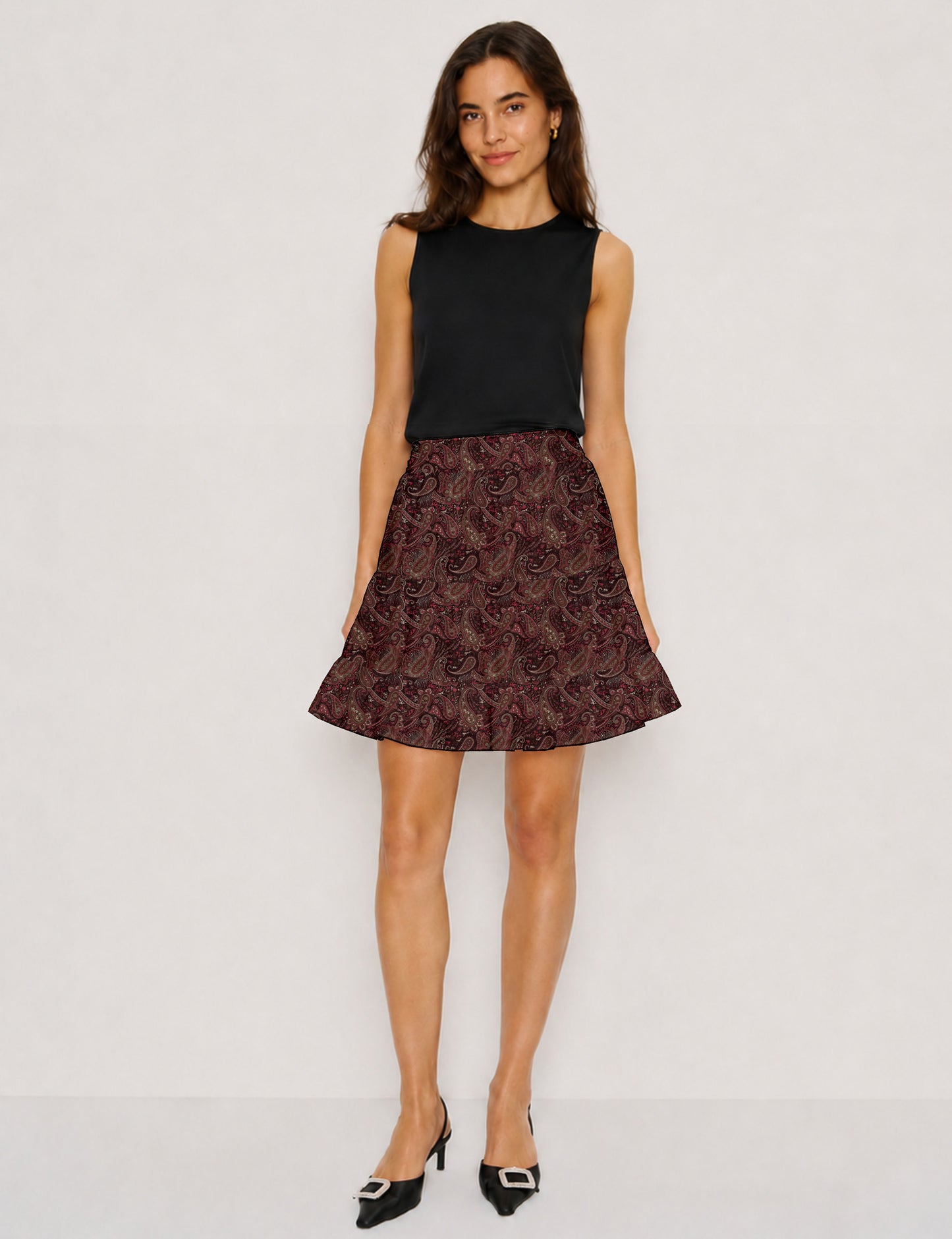 Short tiered skirt with a fitted waistband, knife pleats, softly flared silhouette, side seam pockets, and above-the-knee length.