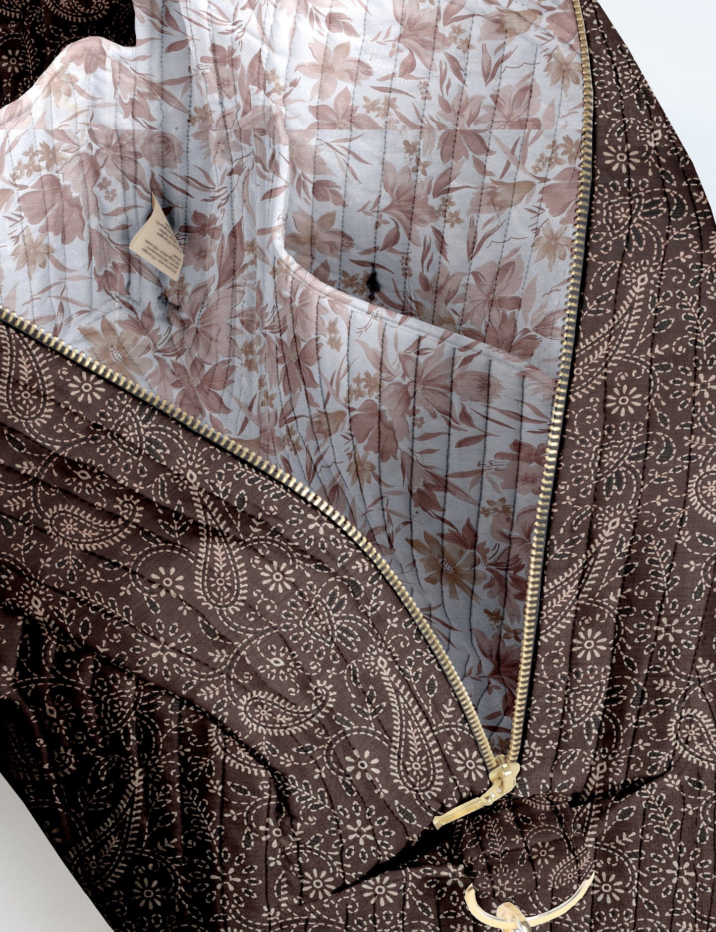 Brown quilted duffle bag with paisley pattern exterior, gold zipper, and floral print fabric interior lining with pocket