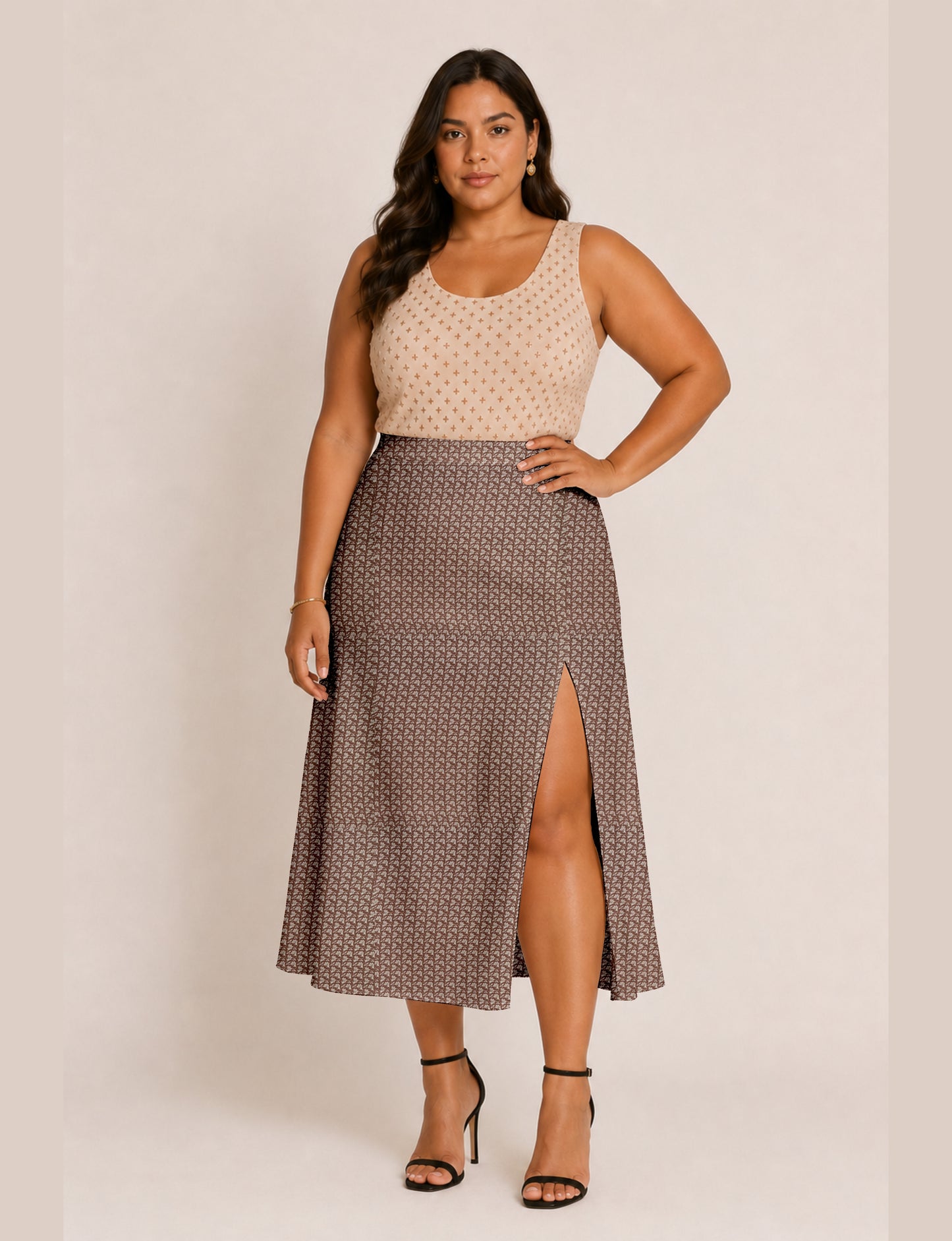 Woman wearing a yellow and black micro patterned A-line skirt with front slit, paired with beige sleeveless top and black