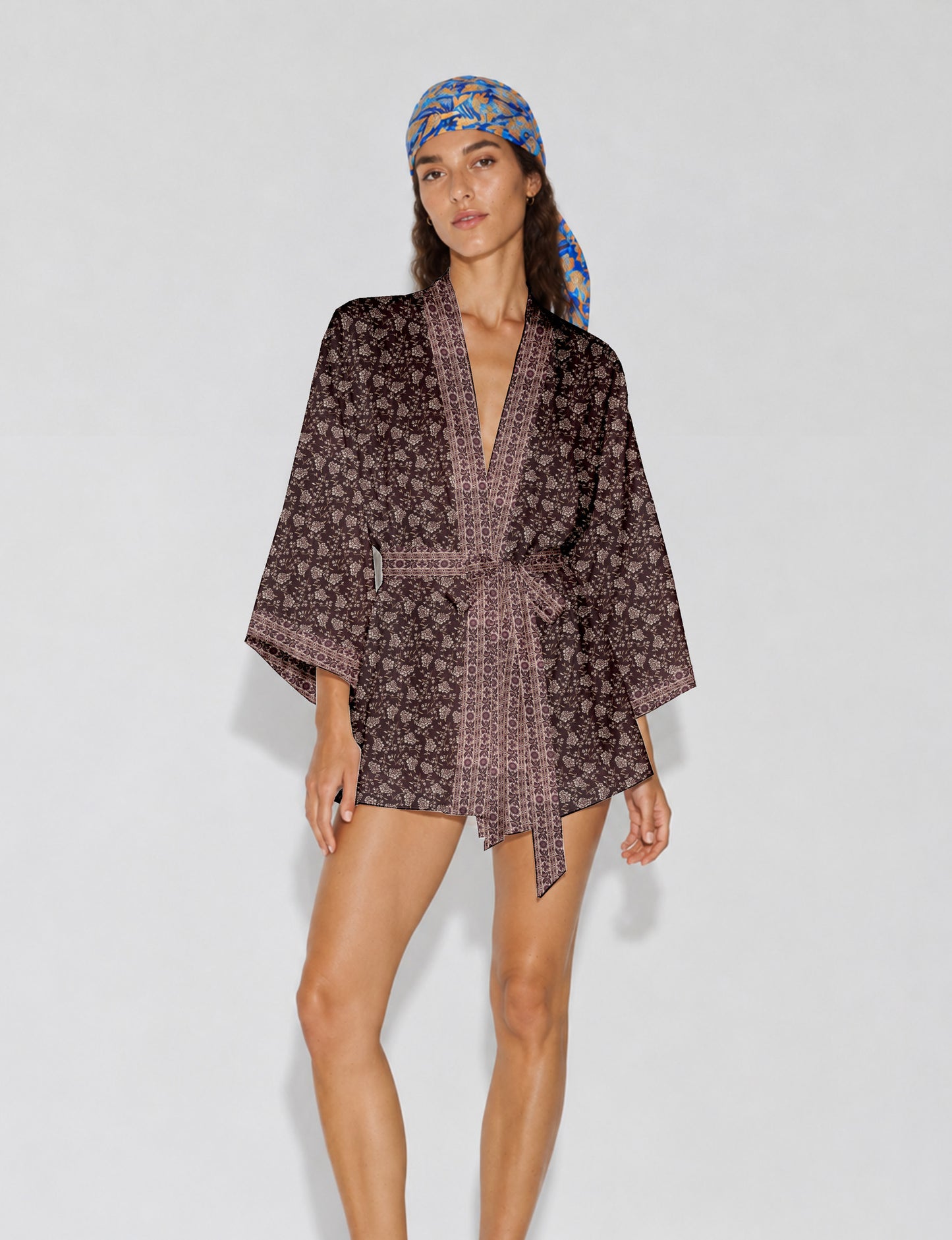 Short kimono robe with wrap front, V-neckline, wide sleeves, waist tie, and concealed skort detail.