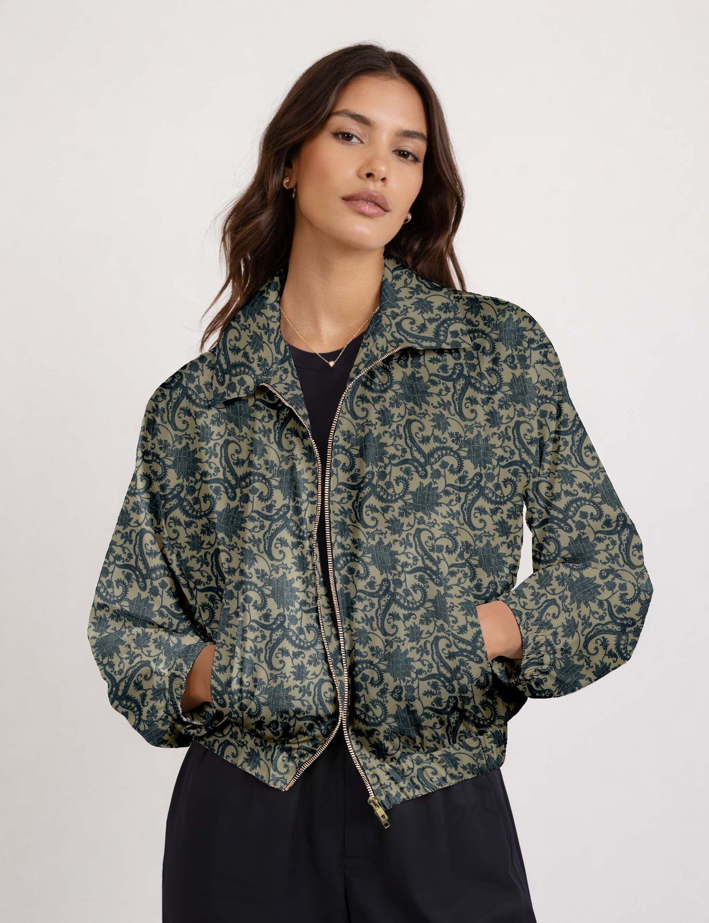 Woman wearing a yellow floral bomber jacket with front zipper, elastic cuffs, and side pockets, shown from front view