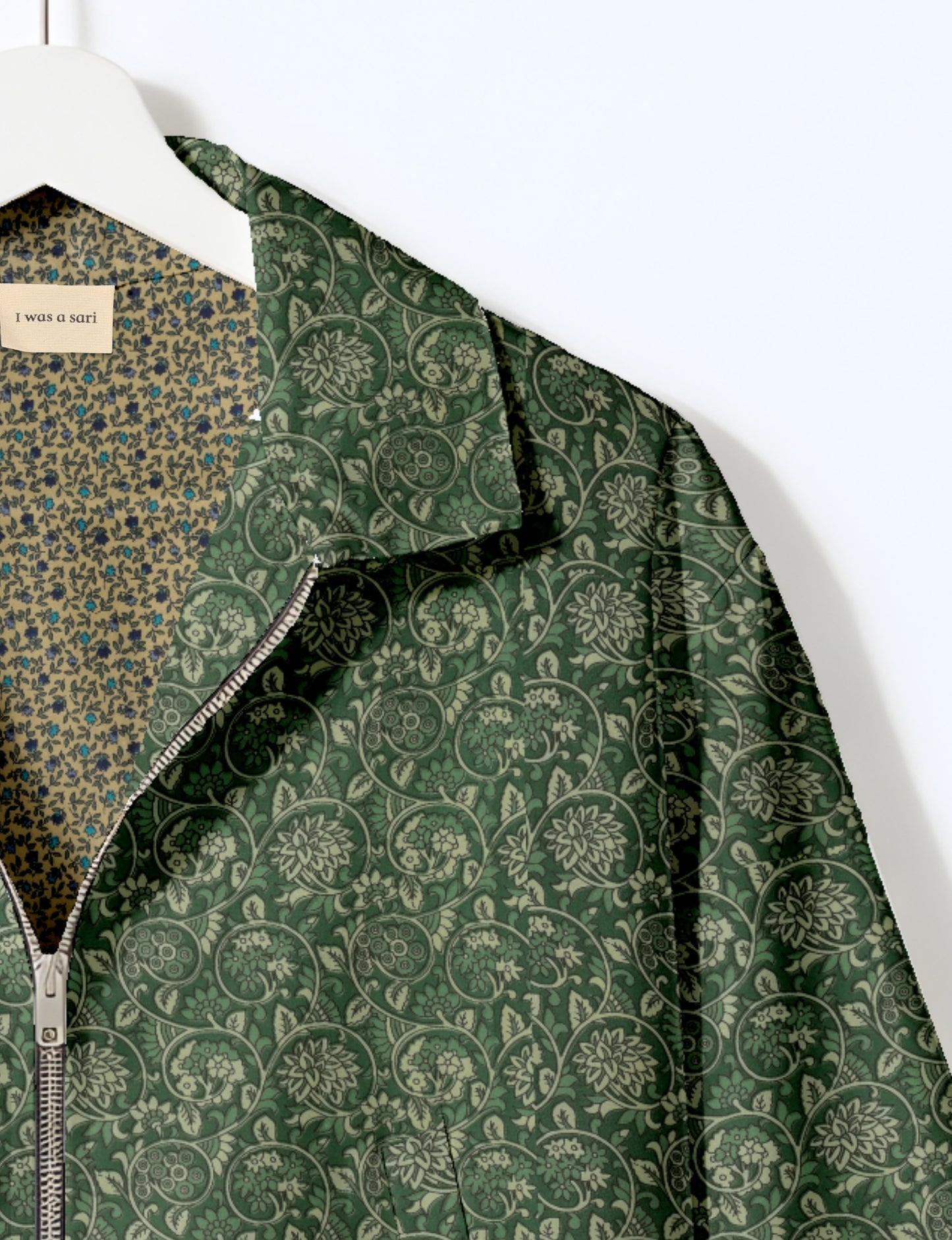 Women's cropped bomber jacket with twin metallic front zippers, welt pockets, elasticated hem and cuffs, and contrast sari print lining.