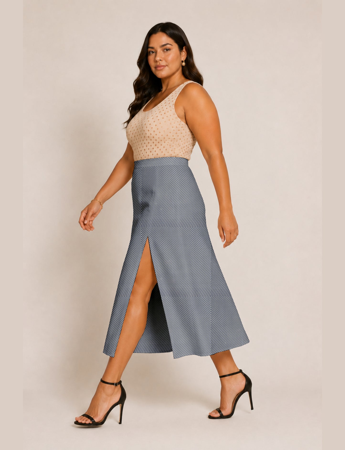 Woman wearing a yellow and navy blue A-line skirt with a slit and a sleeveless beige top with brown micro print