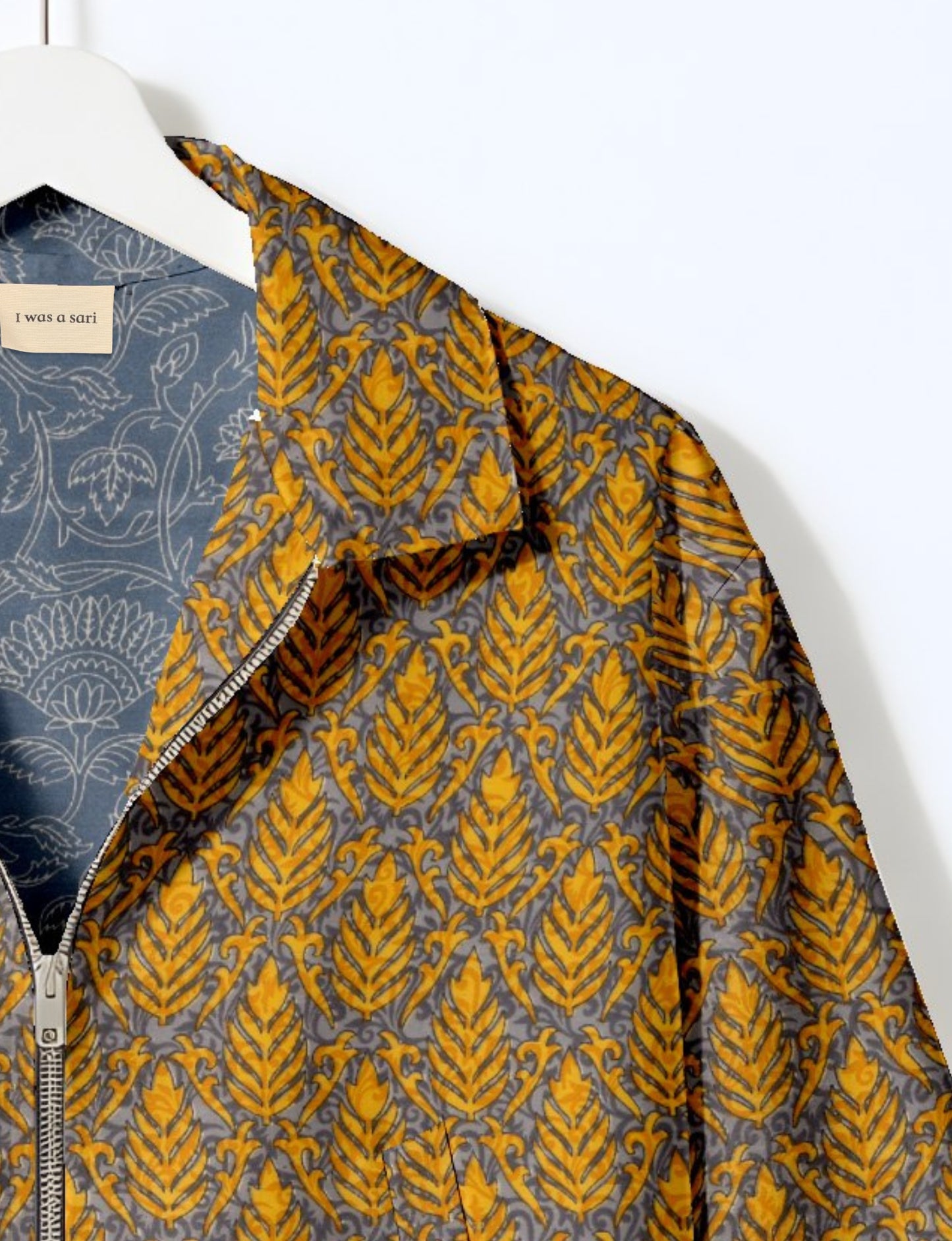 Upcycled Bomber Jacket made from recycled sari materials, featuring a cute cropped shape, elasticated hem and cuffs, and contrast sari print lining. Sustainable apparel promoting eco-friendly fashion and ethical clothing.