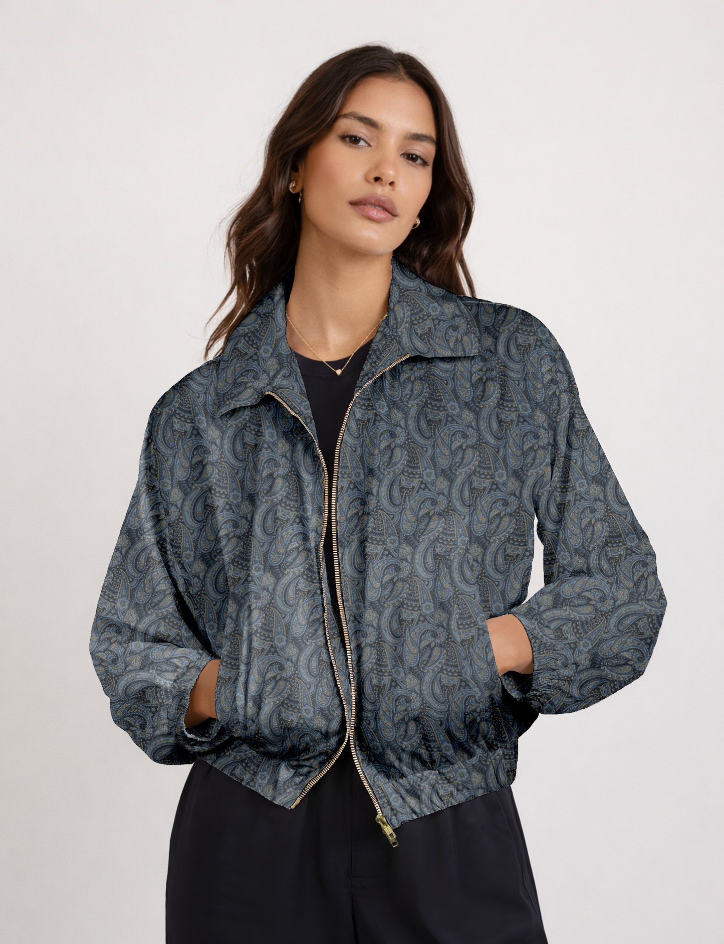 Women's cropped bomber jacket with twin metallic front zippers, welt pockets, elasticated hem and cuffs, and contrast sari print lining.