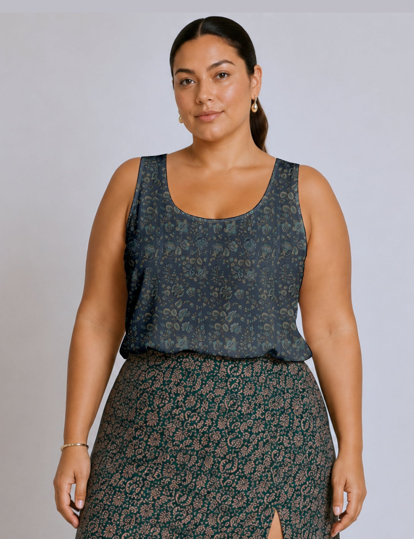 Women's sleeveless blouse with a relaxed straight fit, wide scoop neckline, deep scoop back, and hip-length silhouette.