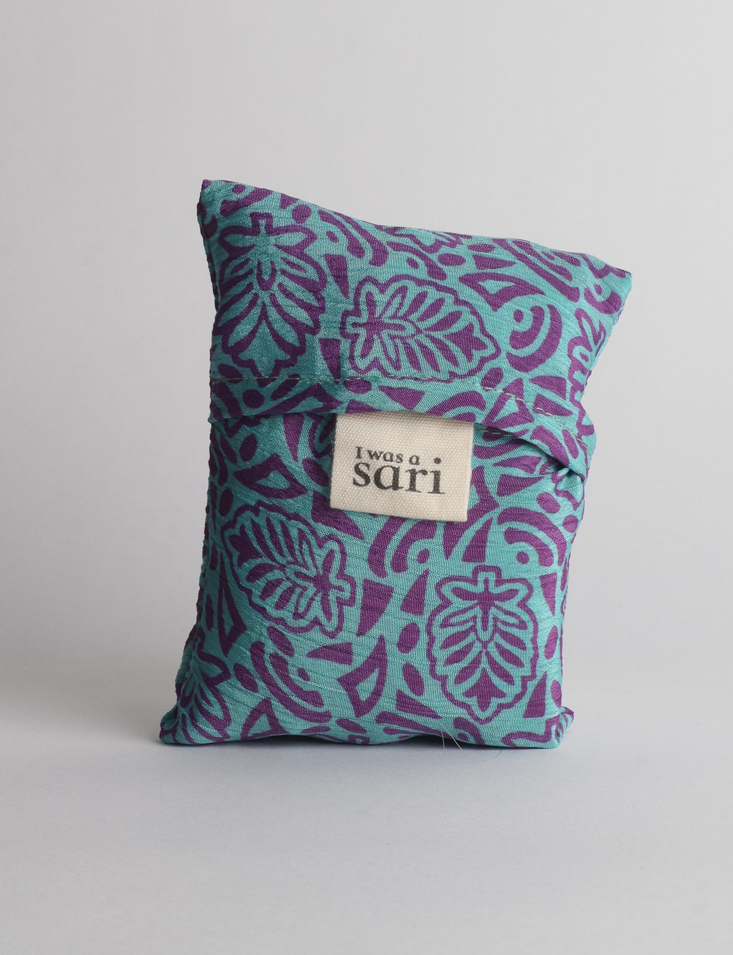 Stay eco-conscious with our Reusable Bag, handmade by Indian artisans from pre-loved saris. Silky and lightweight, this foldaway bag is perfect for your on-the-go lifestyle. Each piece is a unique statement of ethical fashion, embracing sustainability and style.