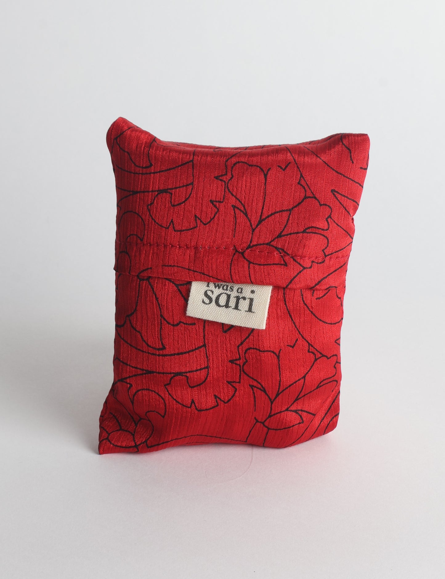 Stay eco-conscious with our Reusable Bag, handmade by Indian artisans from pre-loved saris. Silky and lightweight, this foldaway bag is perfect for your on-the-go lifestyle. Each piece is a unique statement of ethical fashion, embracing sustainability and style.